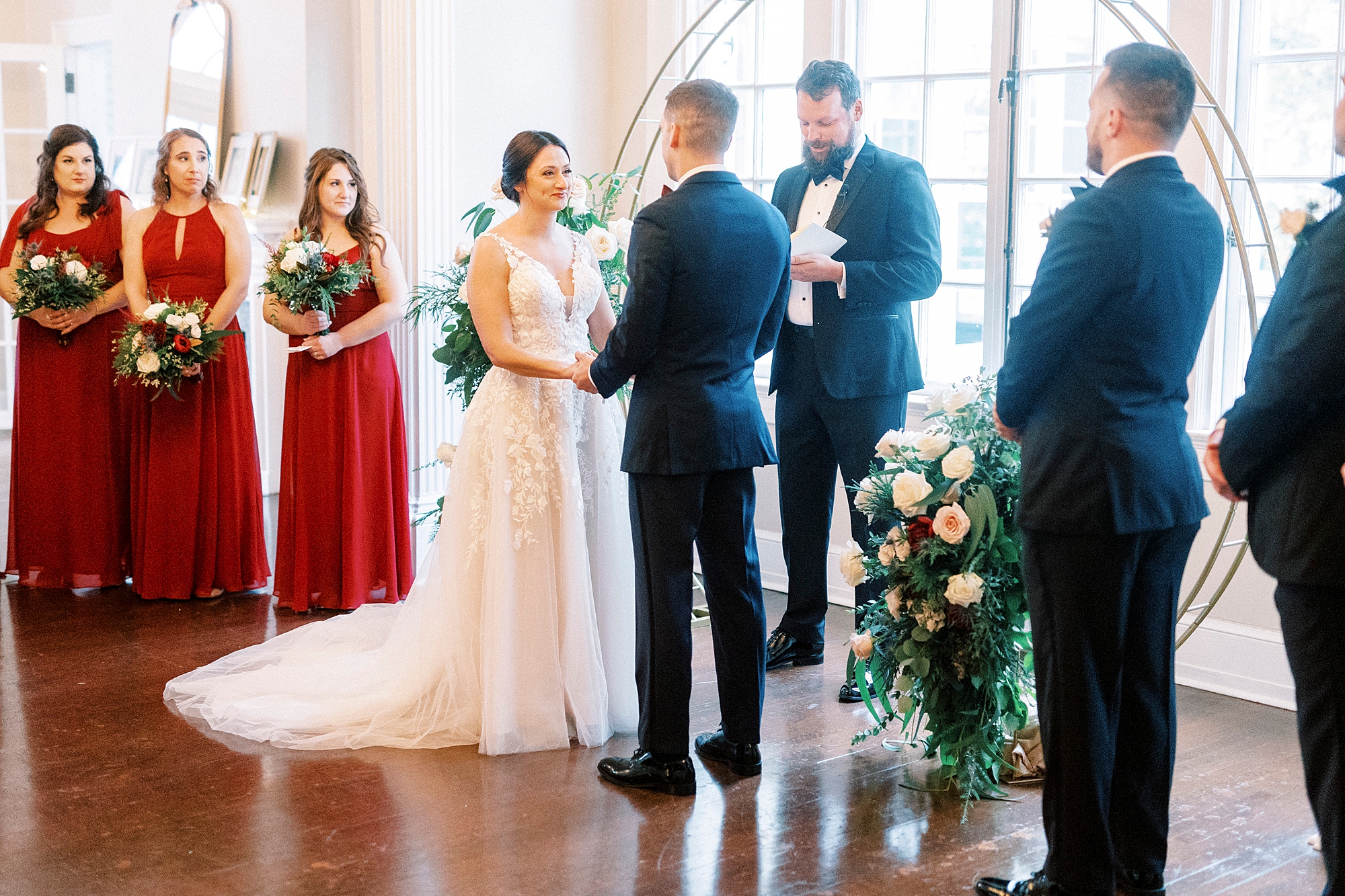 bride and groom hold hands during winter wedding ceremony at Separk Mansion