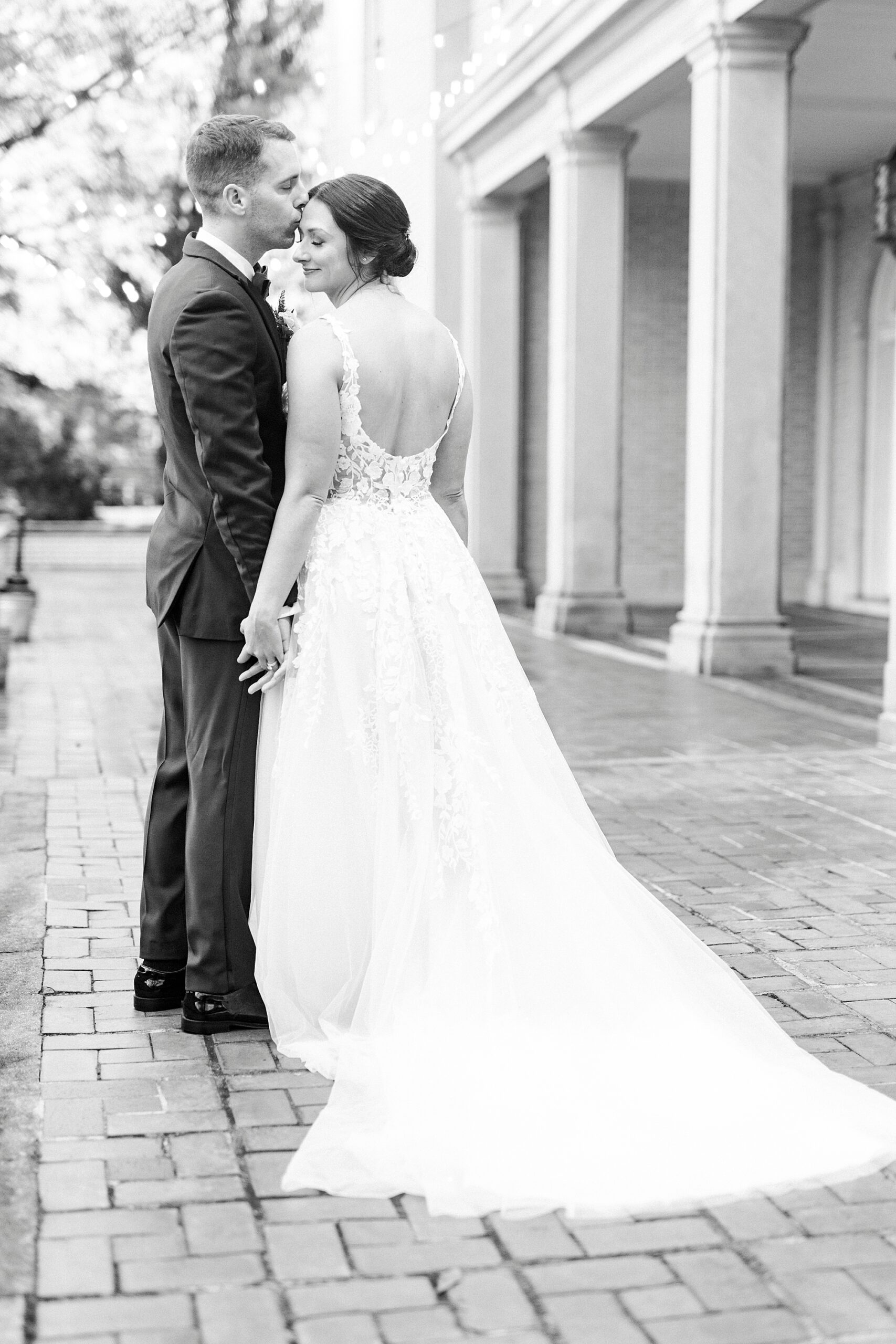 newlyweds hug and hold hands on patio at Separk Mansion