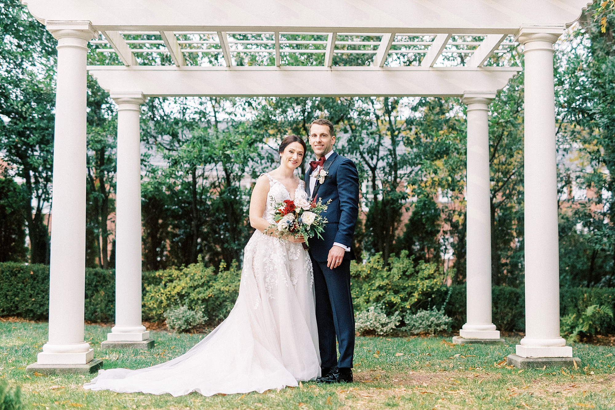 bride and groom hug under the arbor at Separk Mansion