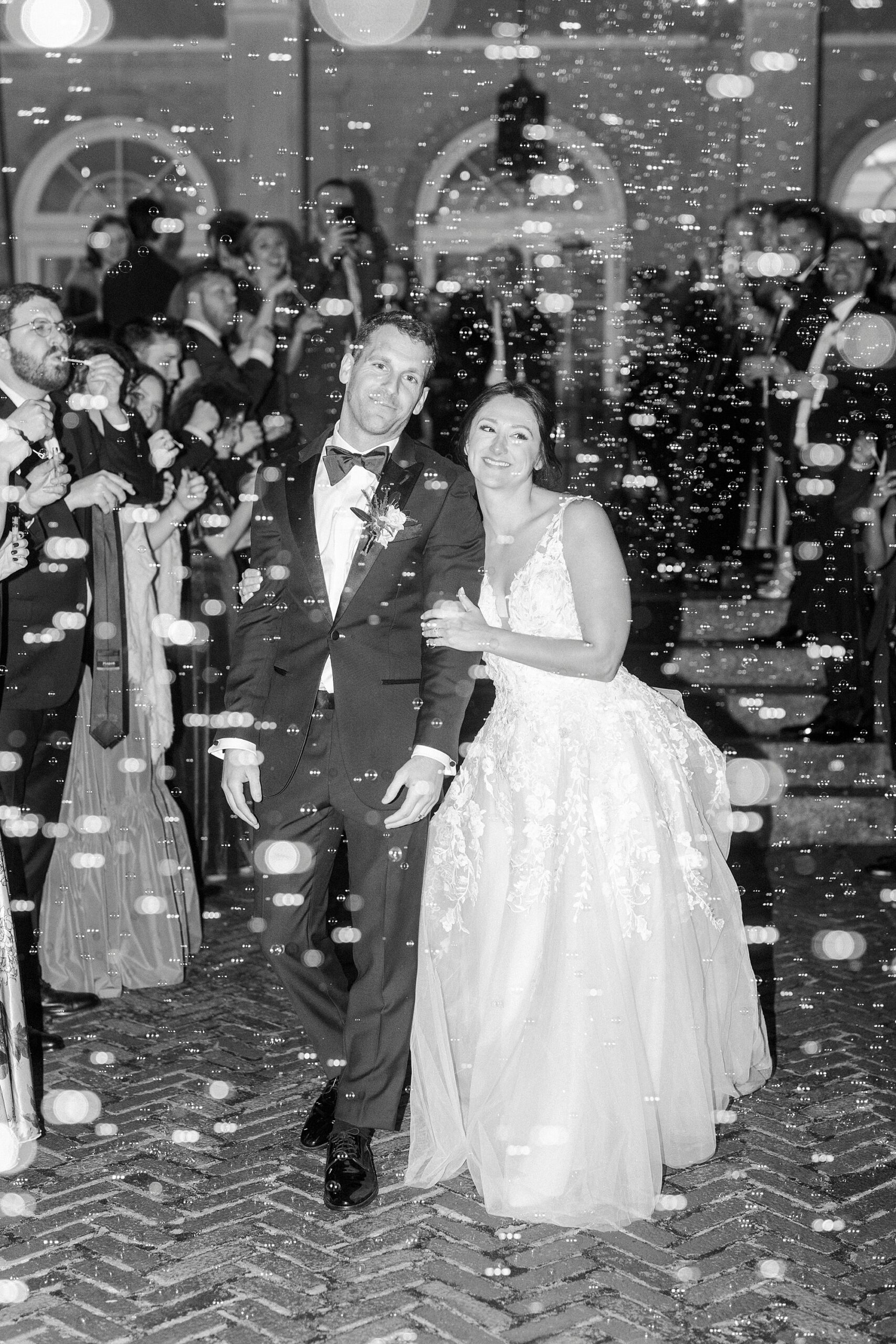 newlyweds hug walking through bubble exit at Separk Mansion