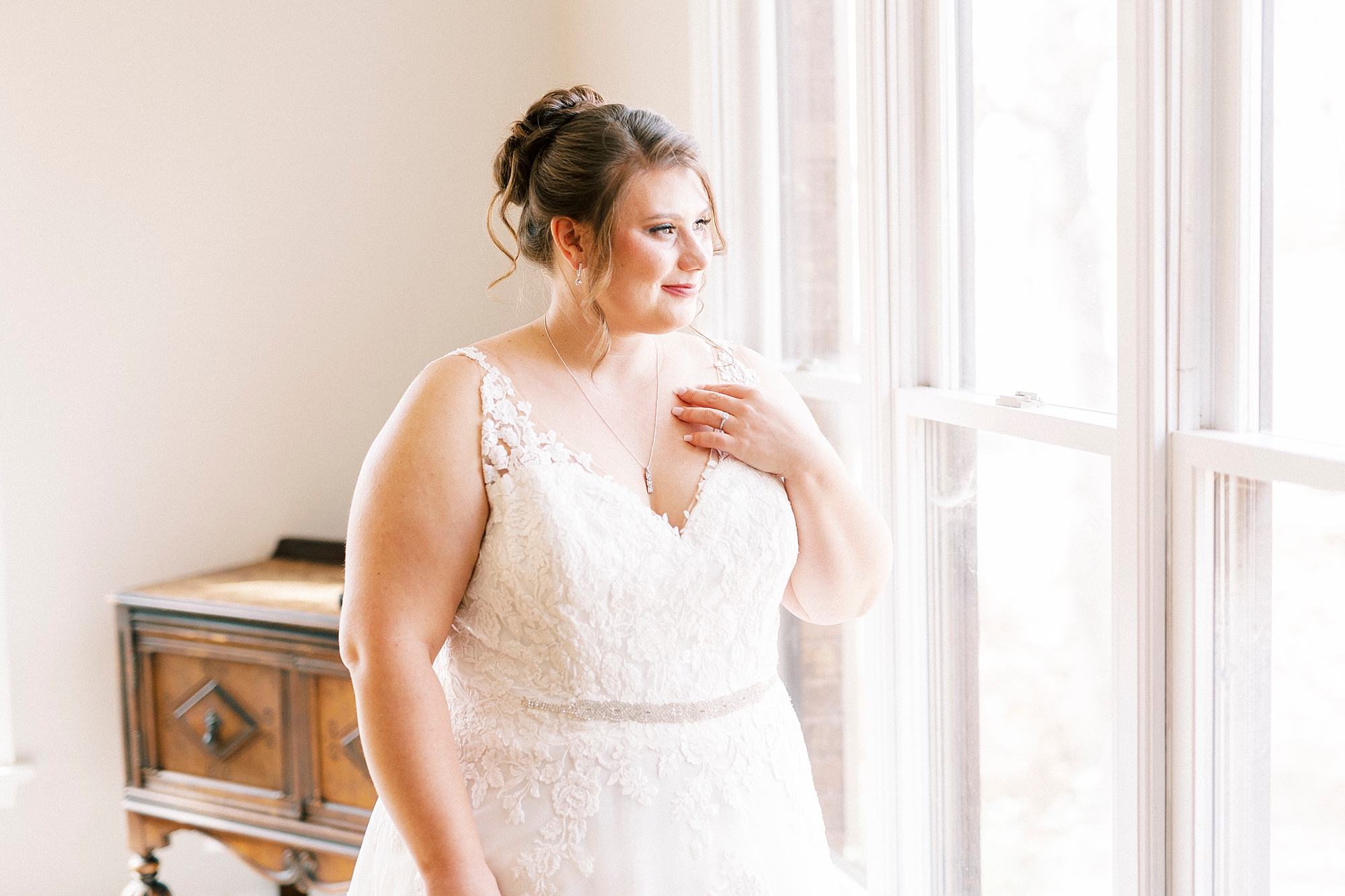 bride looks out window at the Farm at Brusharbor