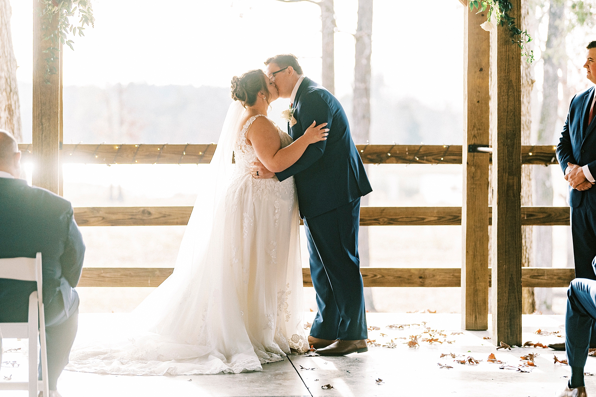 bride and groom kiss during wedding ceremony at the Farm at Brusharbor pavilion 
