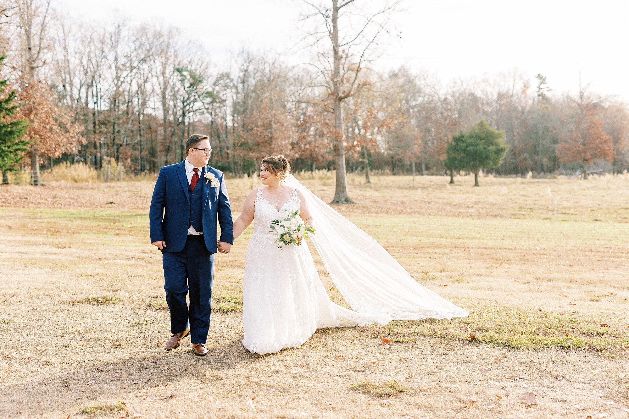 bride and groom hold hands walking on lawn at the Farm at Brusharbor