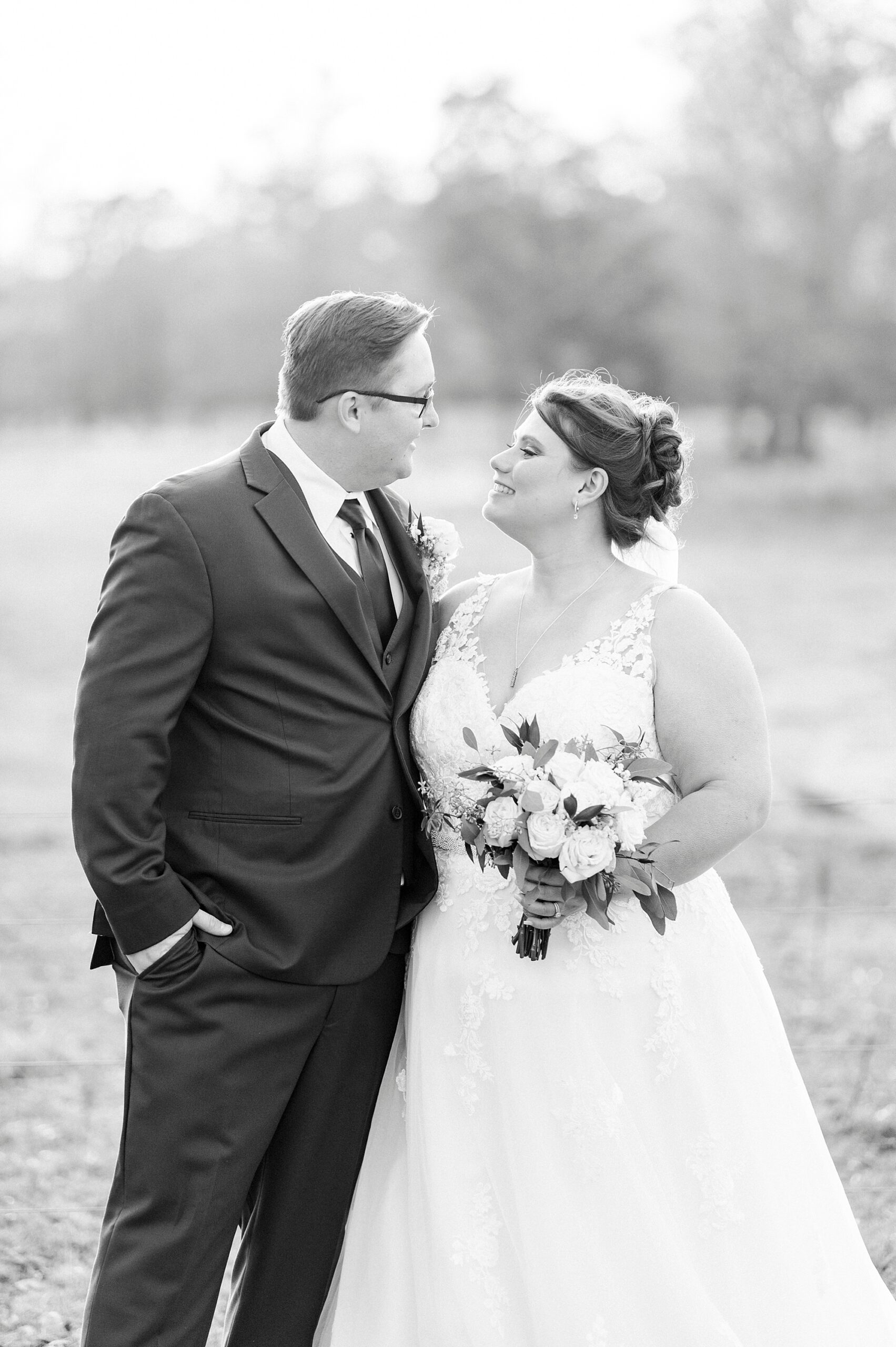 bride and groom hug facing each other on the lawn at the Farm at Brusharbor