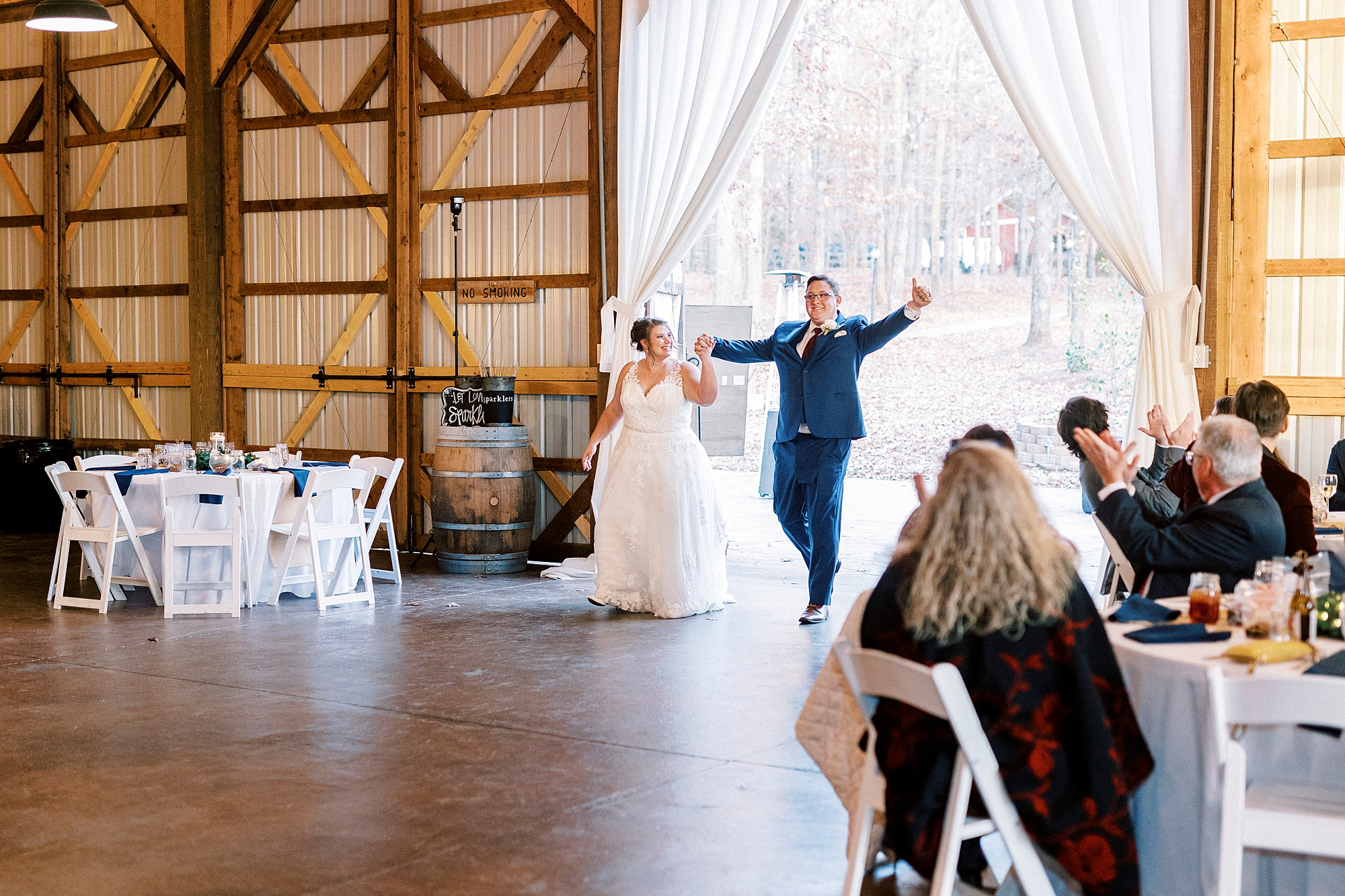 bride and groom cheer walking into reception at the Farm at Brusharbor
