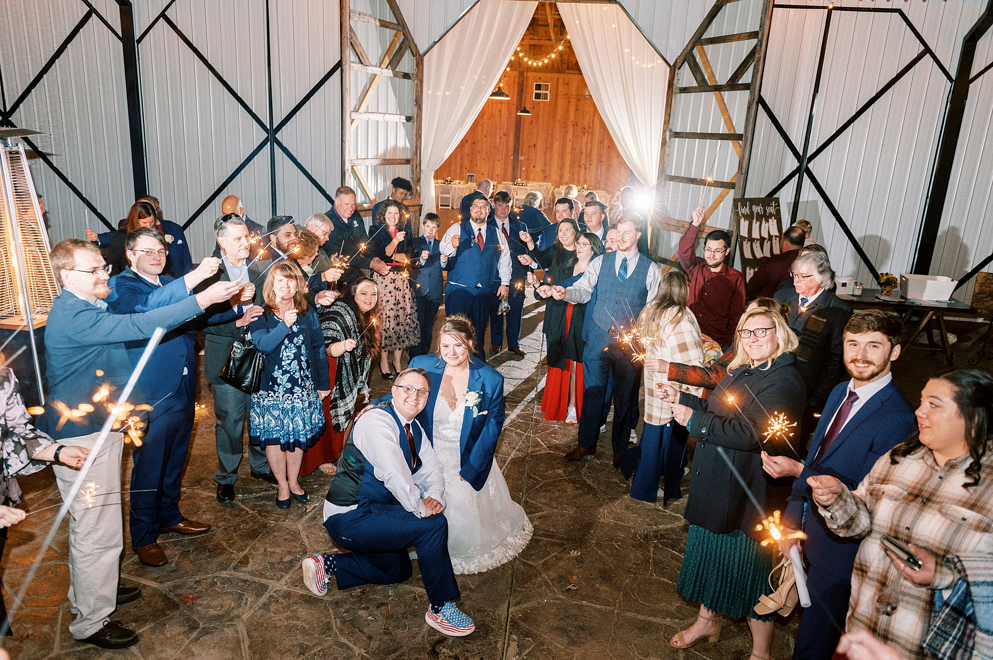 bride and groom pose in front of guests during sparkler exit at the Farm at Brusharbor