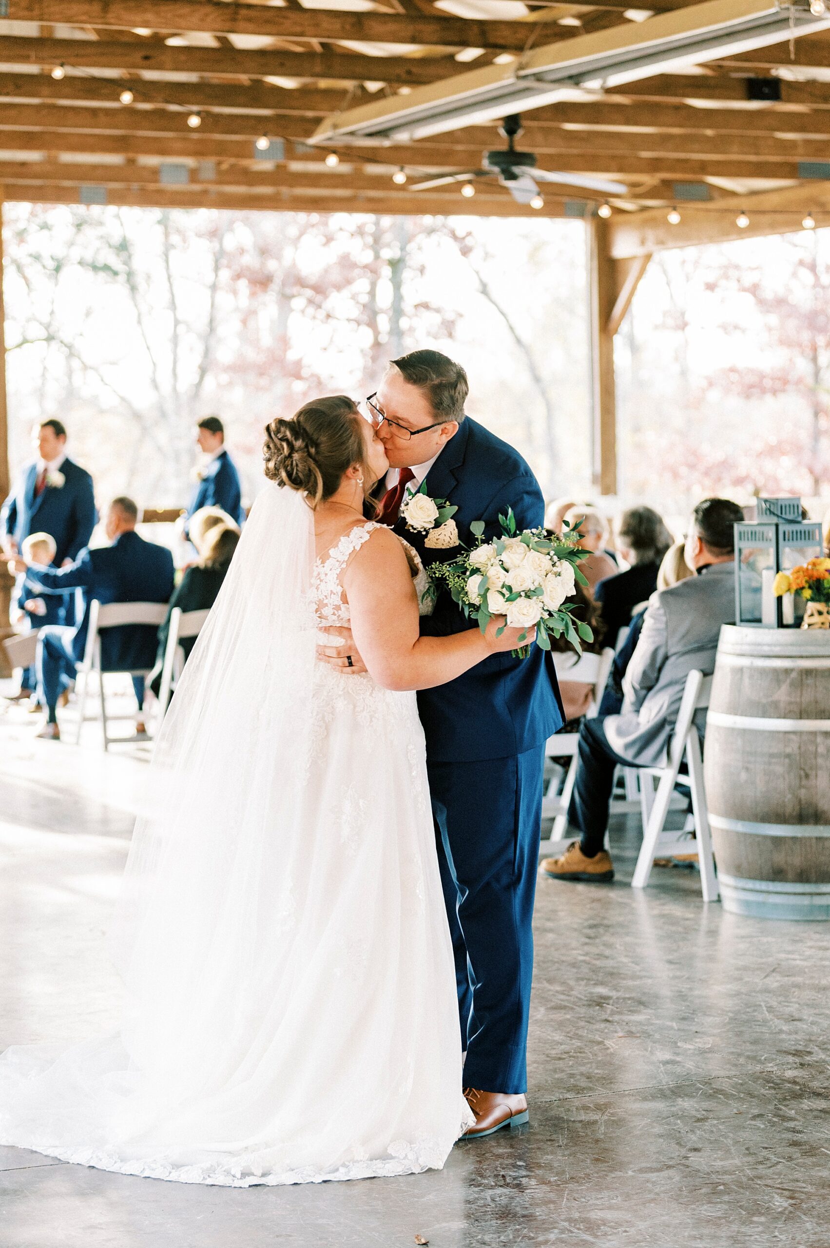 bride and groom kiss leaving wedding ceremony at the Farm at Brusharbor
