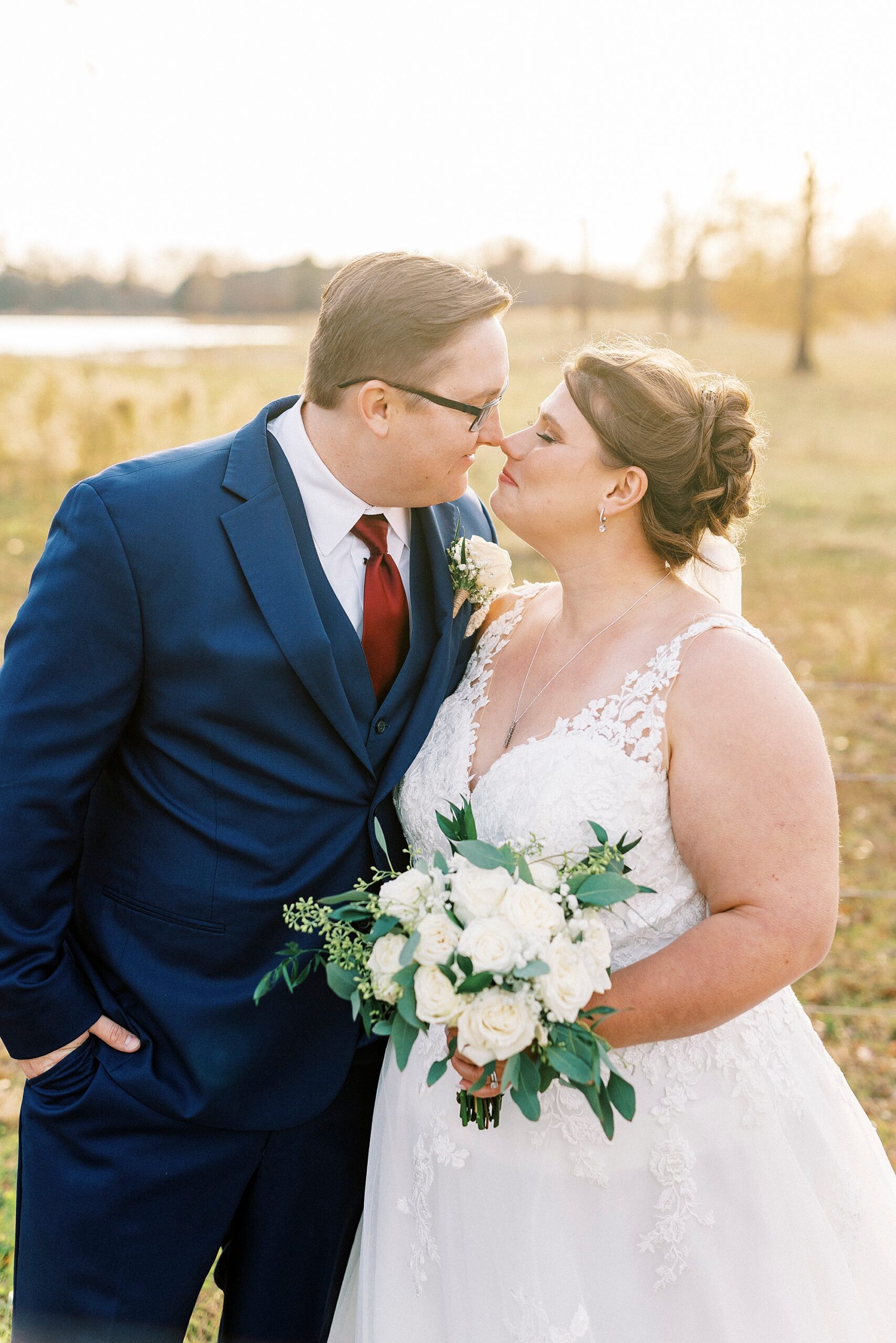 bride and groom lean faces together at sunset during portraits at the Farm at Brusharbor 