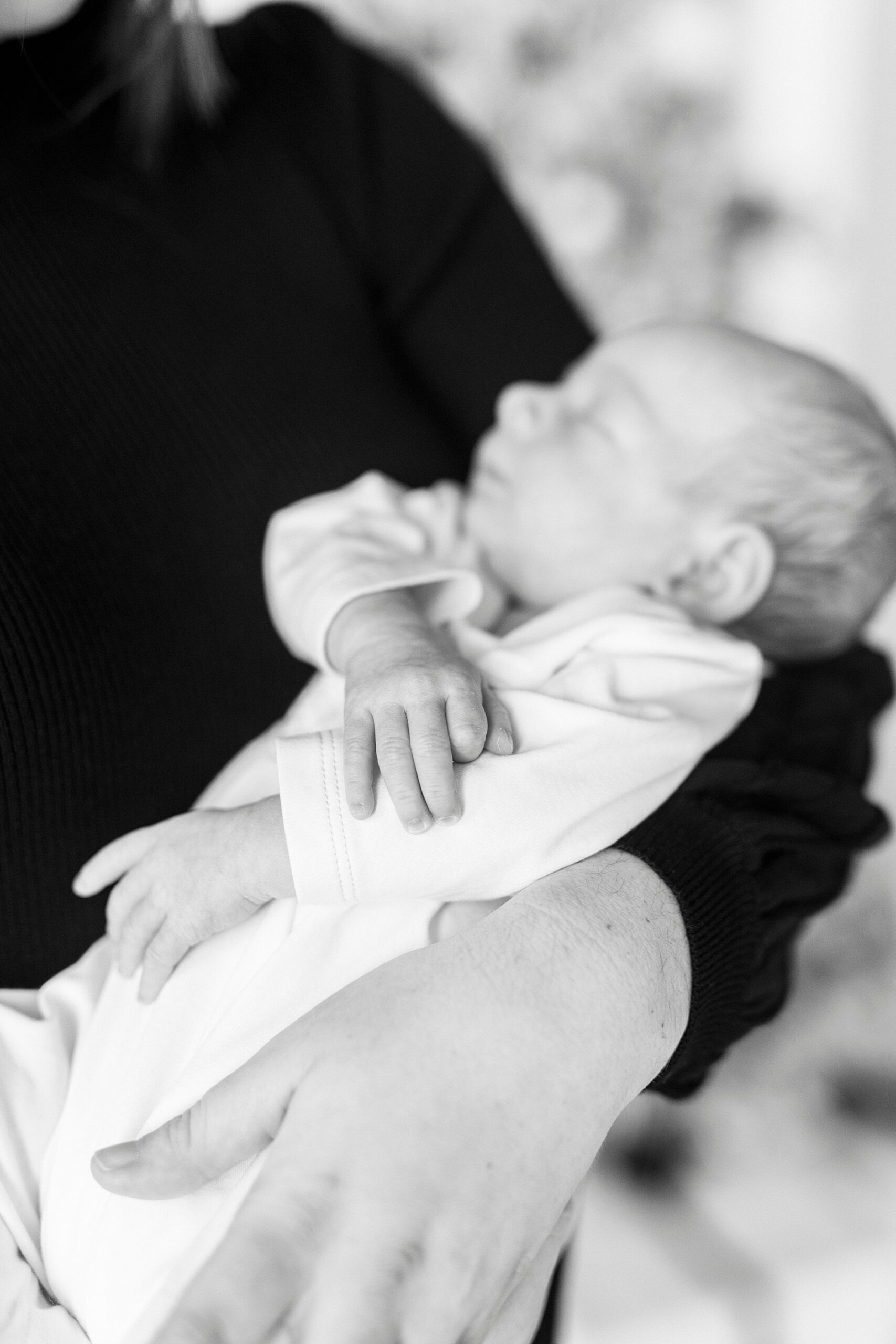 woman hugs baby boy to her chest during studio holiday portraits 