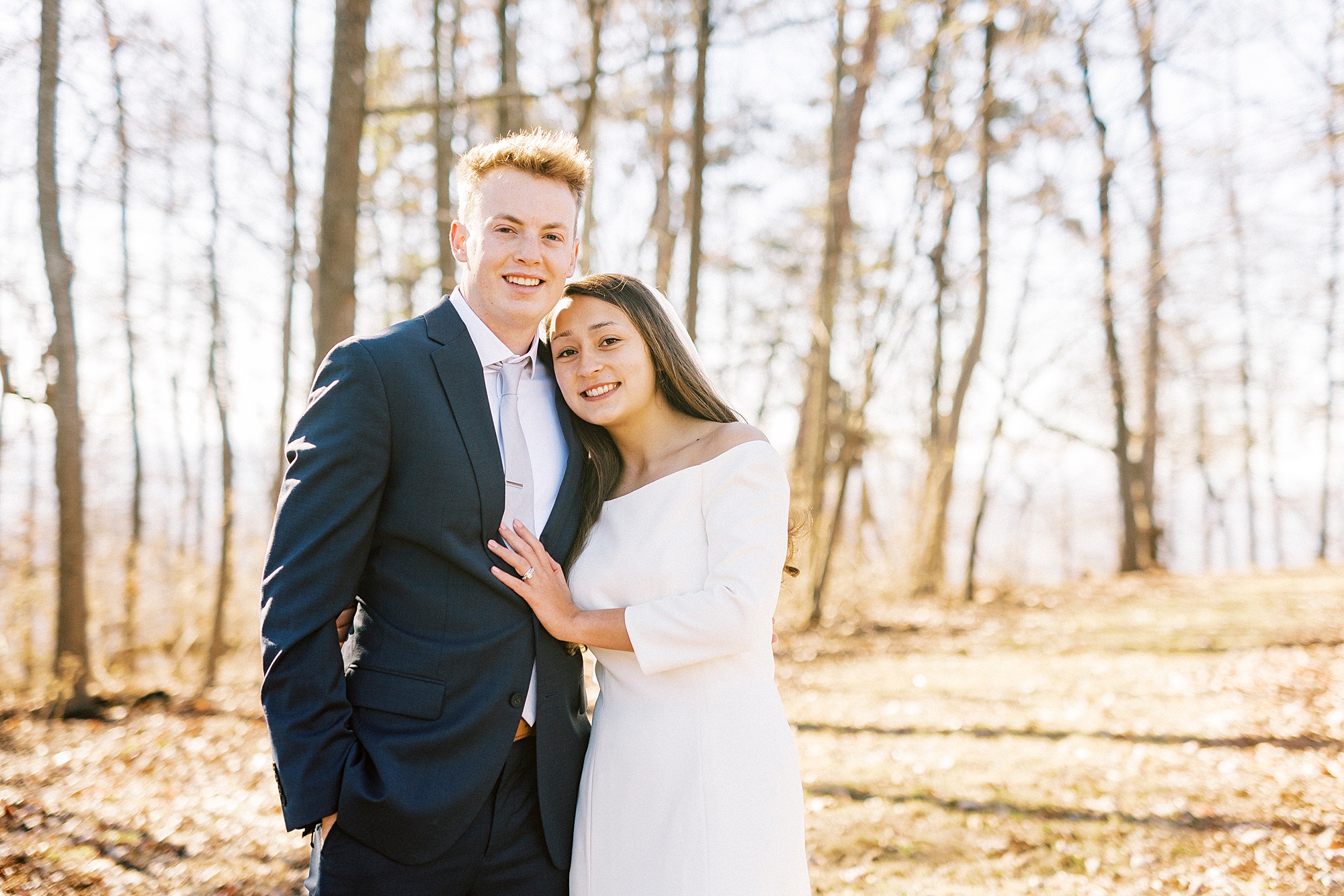 bride hugs groom leaning into him during portraits at Morrow Mountain