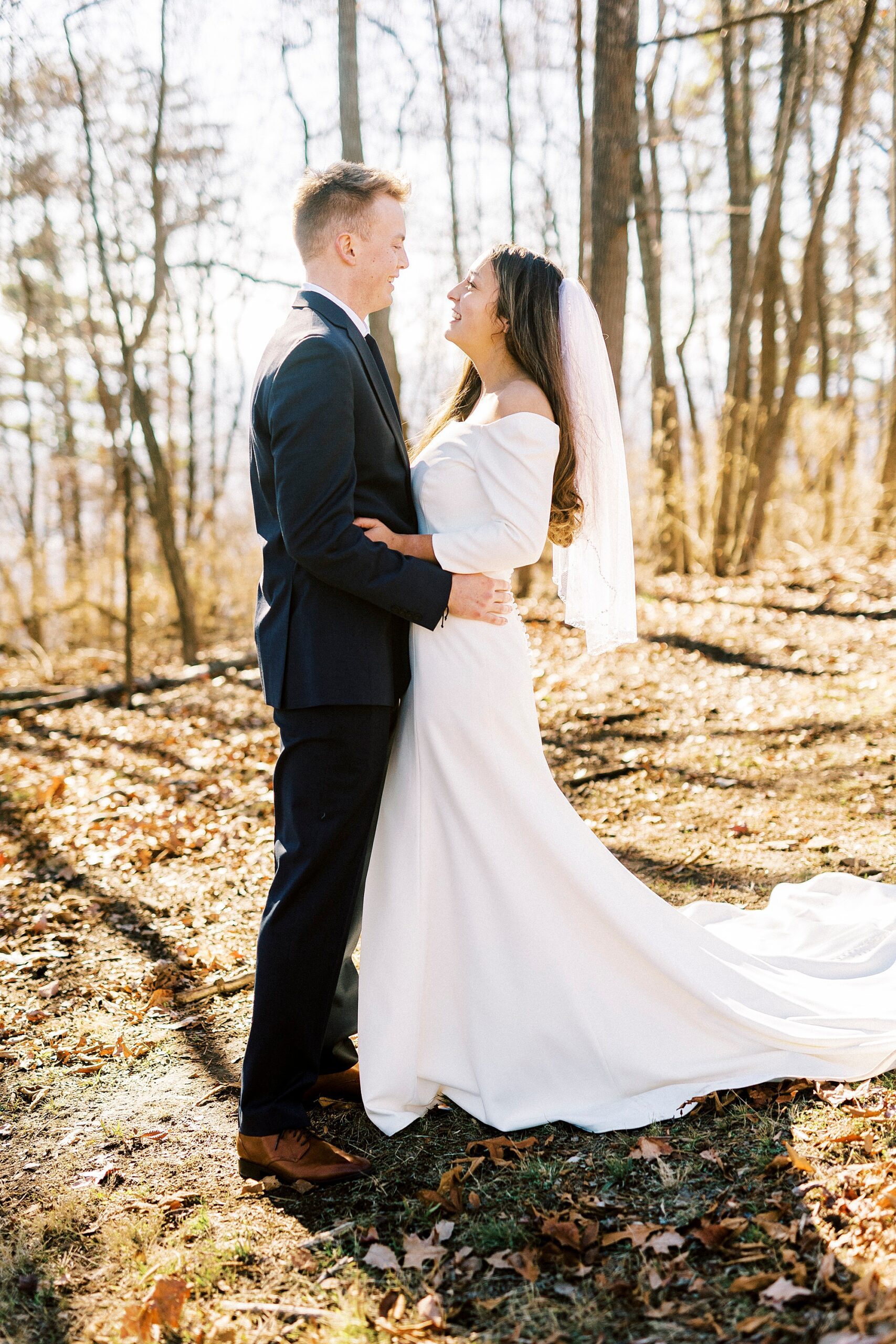 bride and groom hug facing each other on Morrow Mountain 