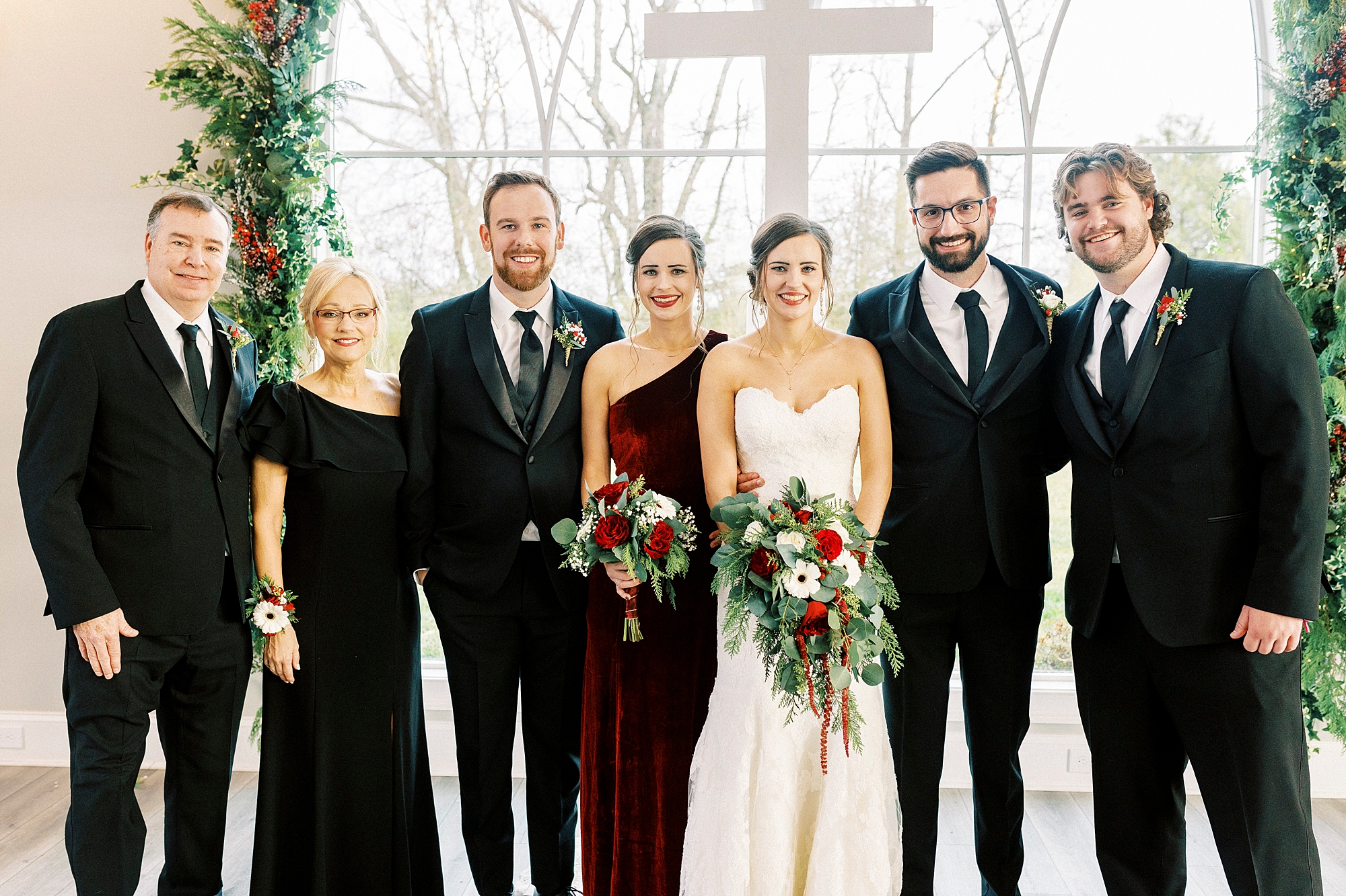 bride and groom pose with parents after Chickadee Hill Farms wedding ceremony