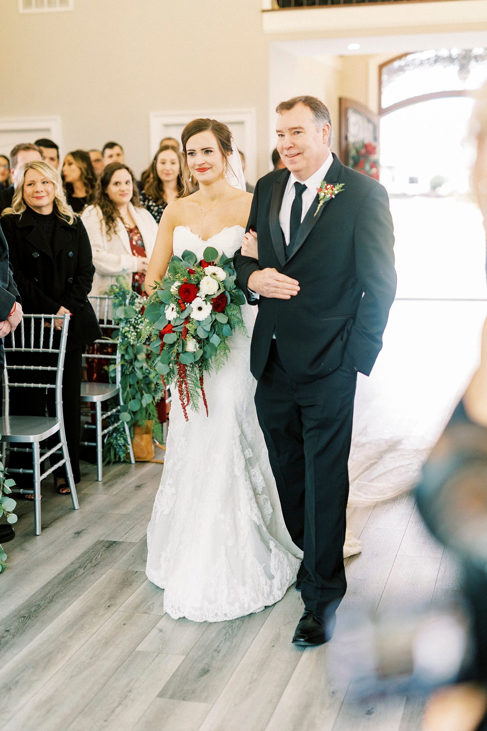 father escorts bride down aisle inside chapel at Chickadee Hill Farms
