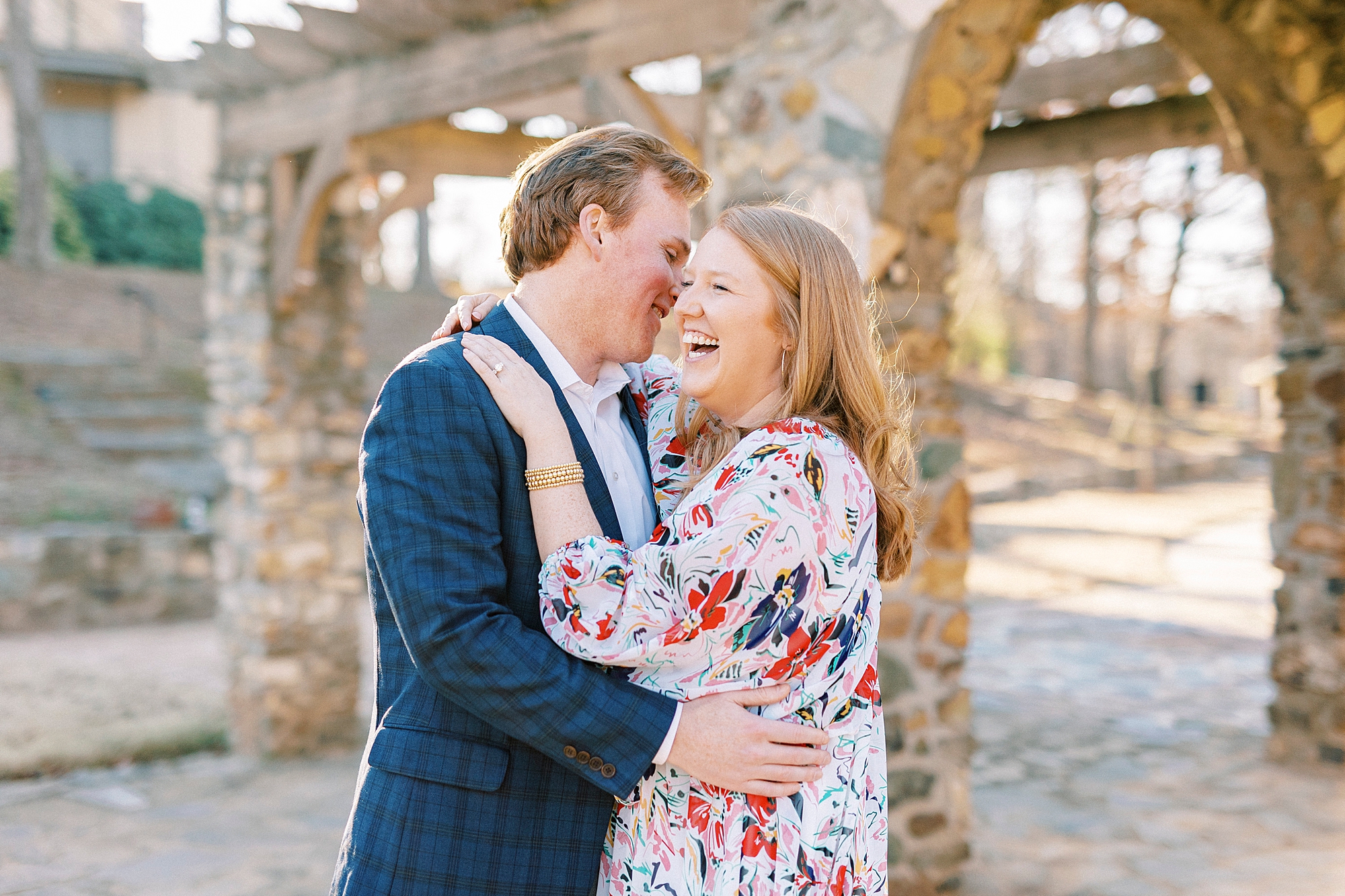 man makes fiancee laugh during Independence Park engagement portriats