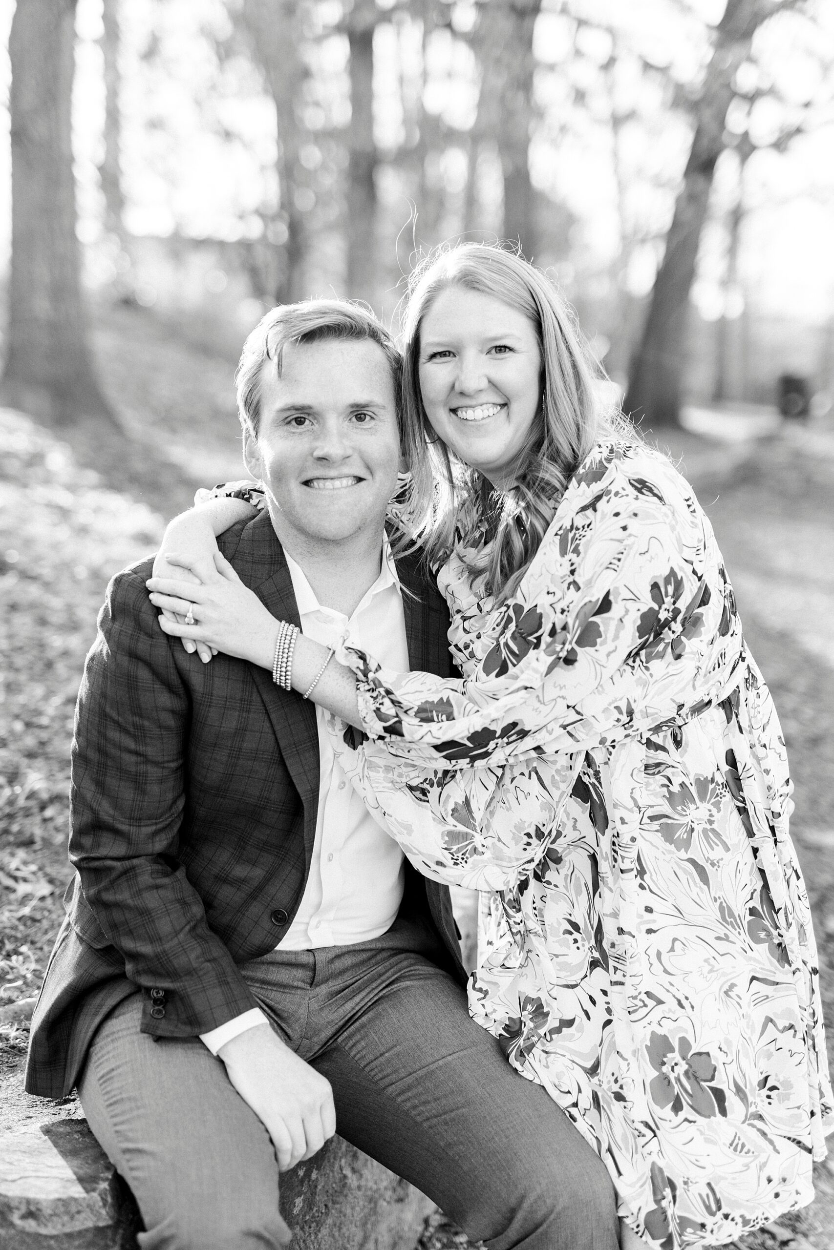 couple hugs in front of stone wall at Independence Park