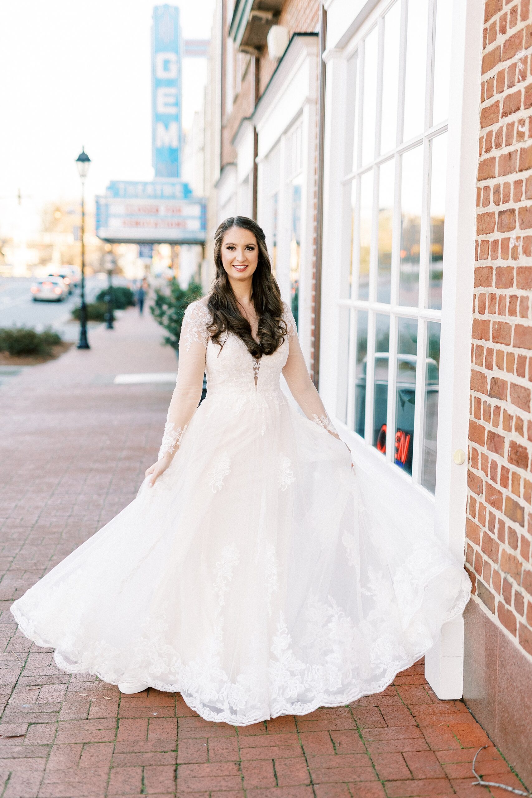 bride twirls in wedding dress during bridal portraits Downtown Kannapolis