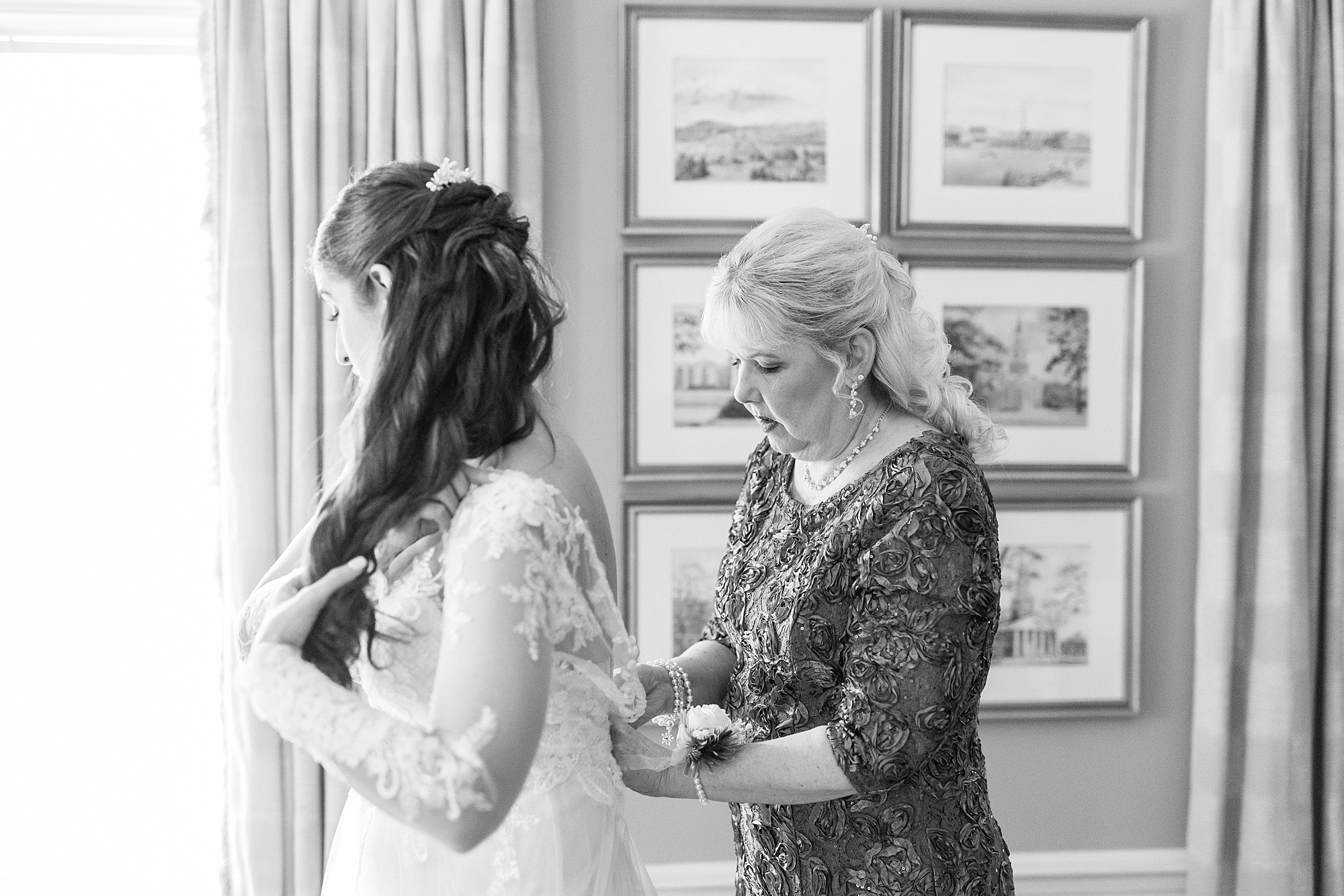 mother helps bride with back of wedding gown before Downtown Kannapolis wedding