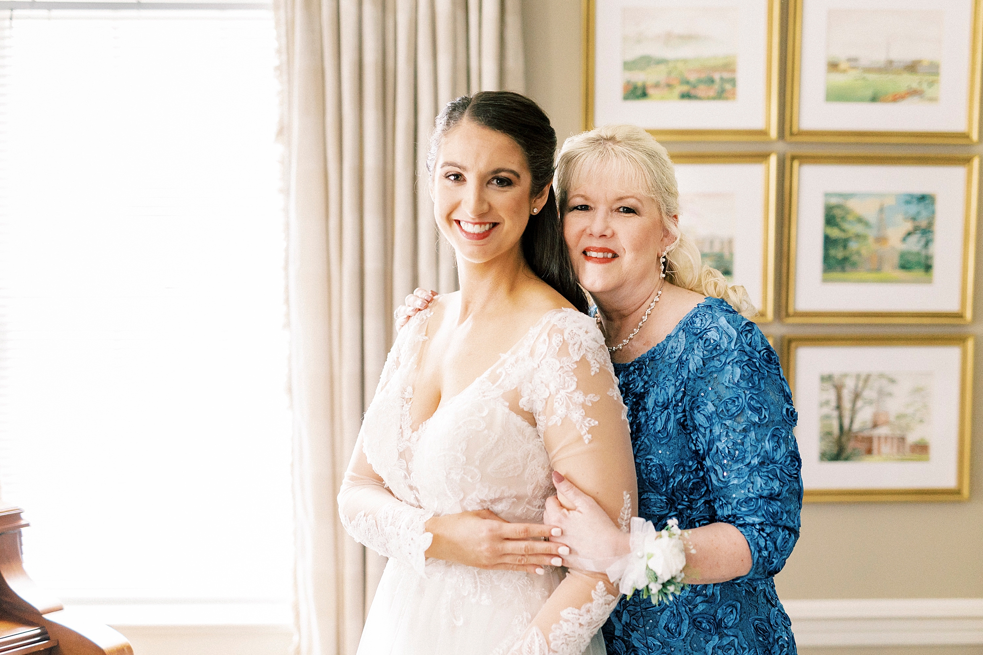 mother hugs bride from behind after prep for wedding