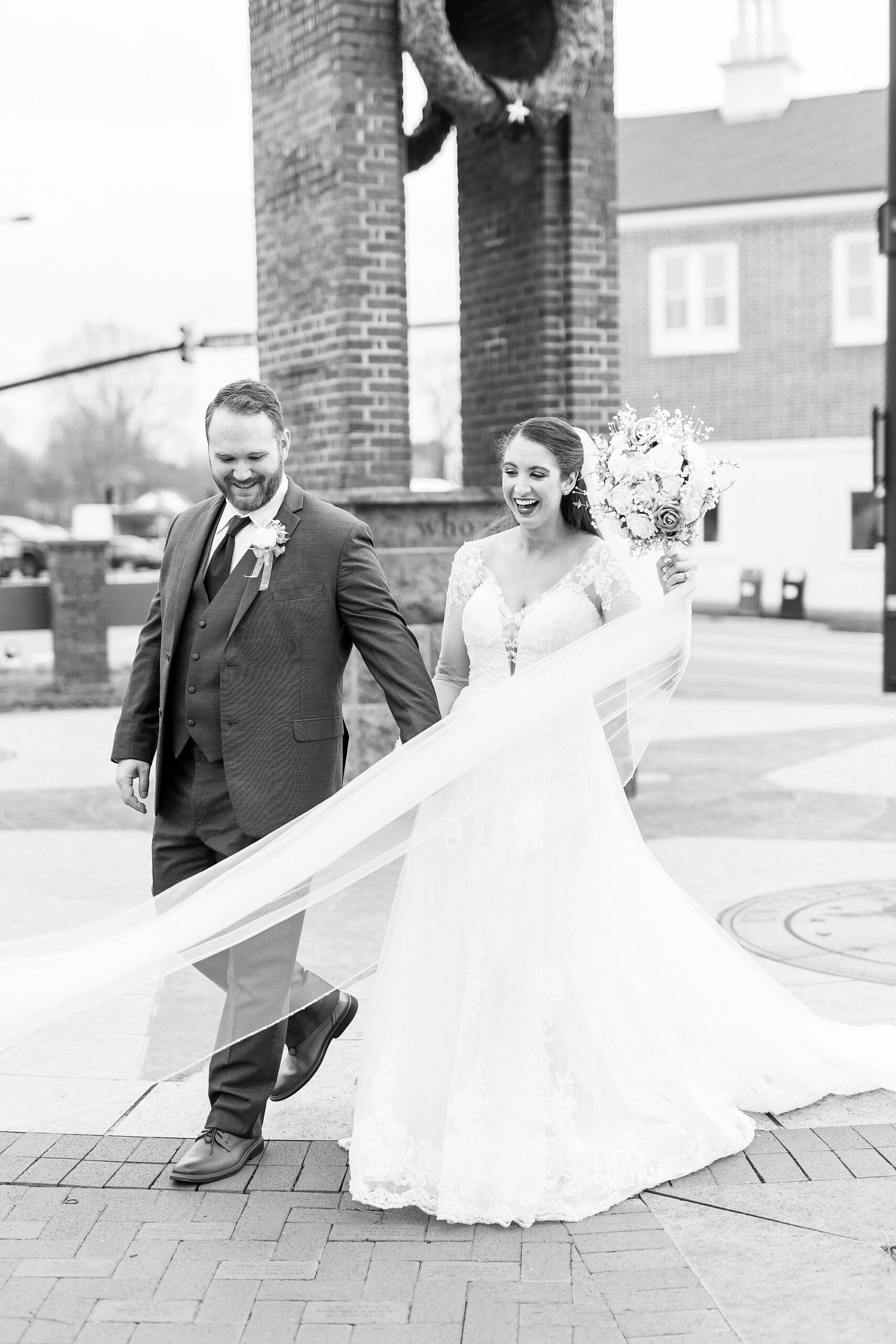 bride and groom walk through downtown Kannapolis
