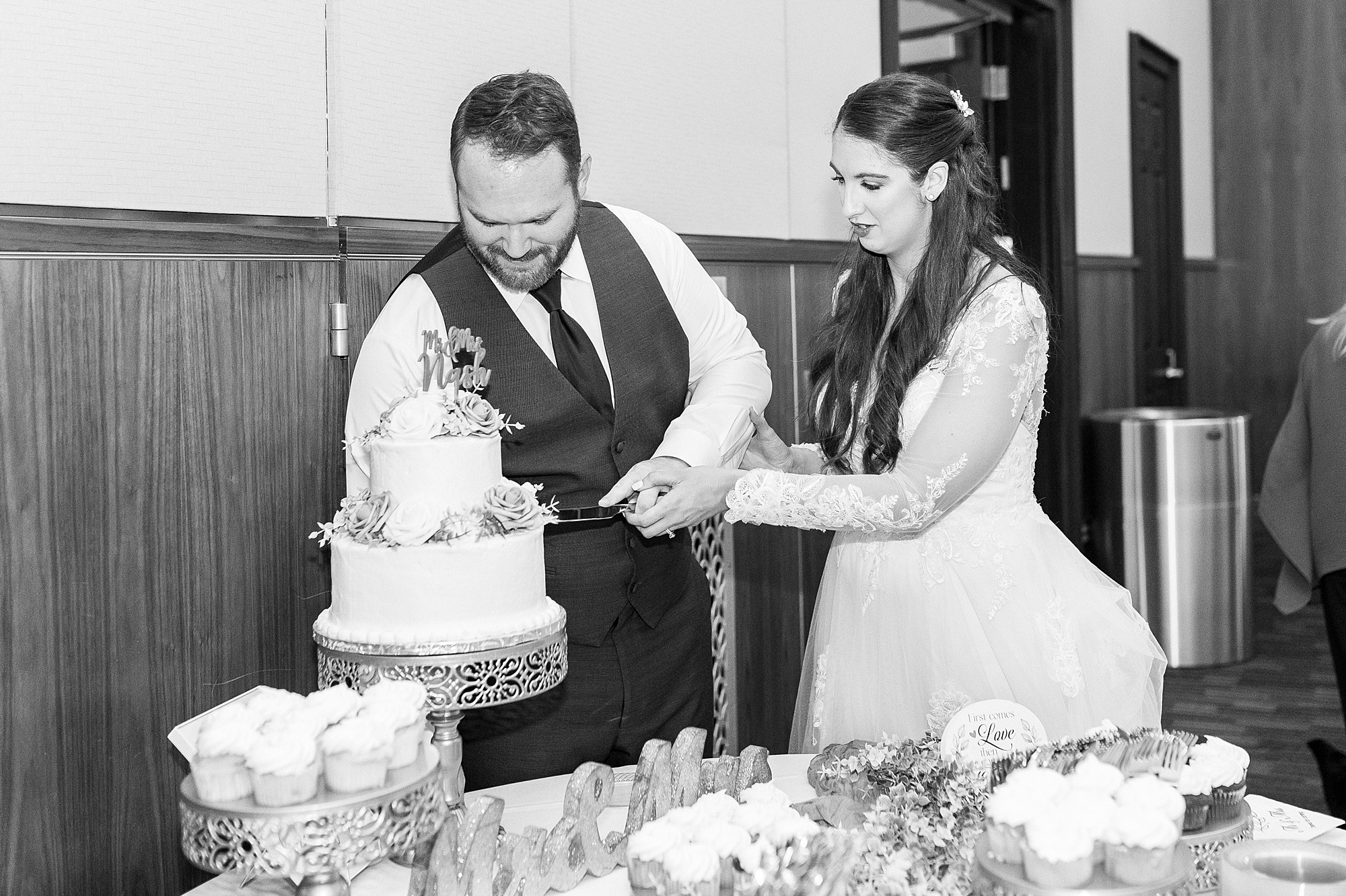 bride and groom cut wedding cake during reception