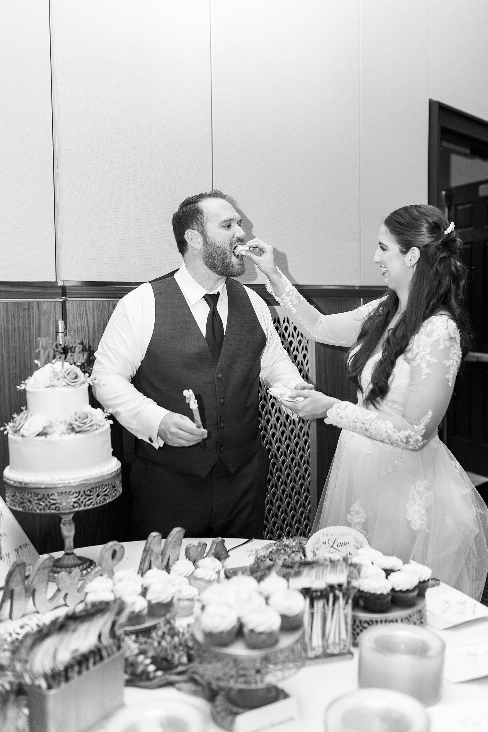 bride and groom cut wedding cake during reception