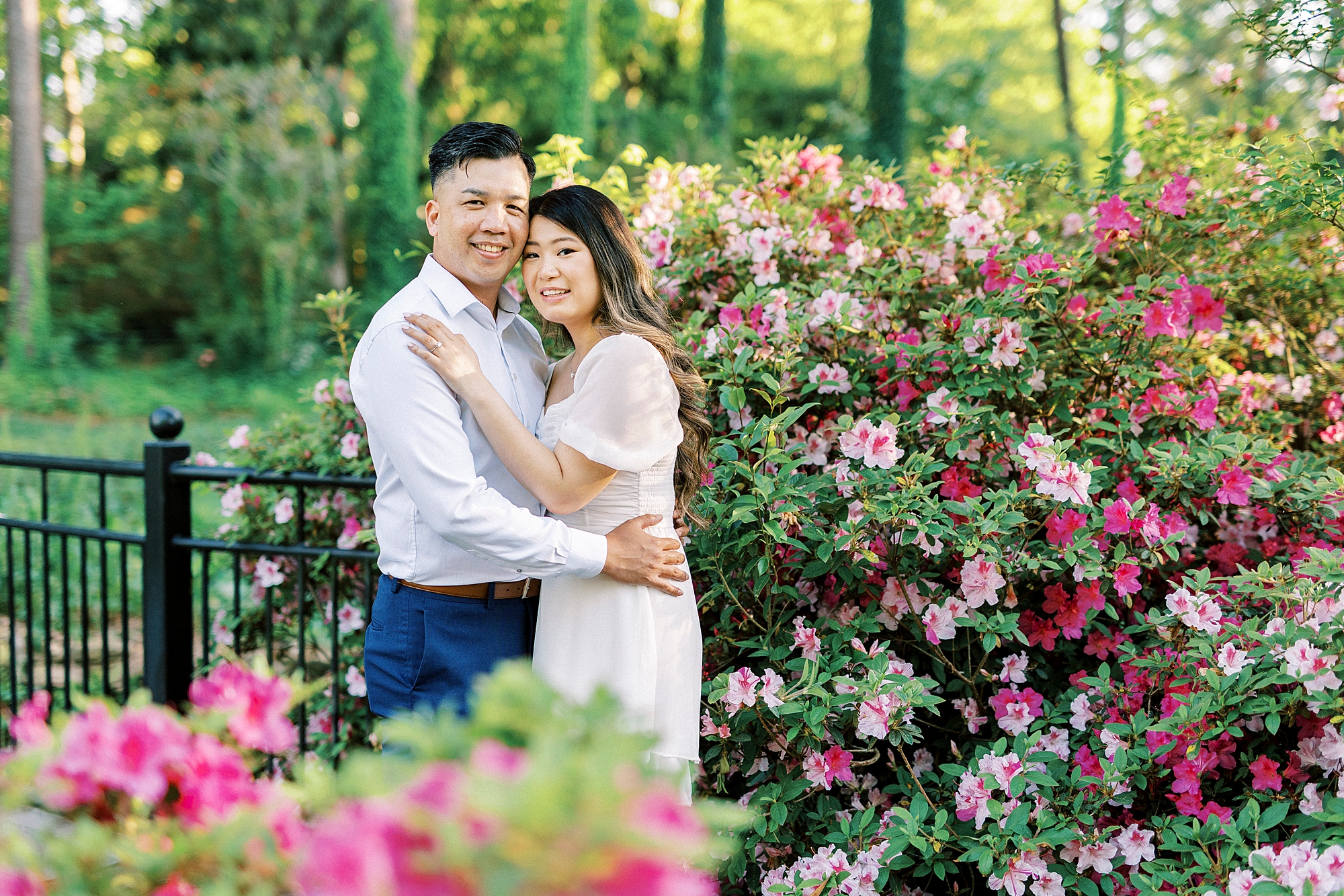 woman hugs man leaning into his chest inside Glencairn Garden