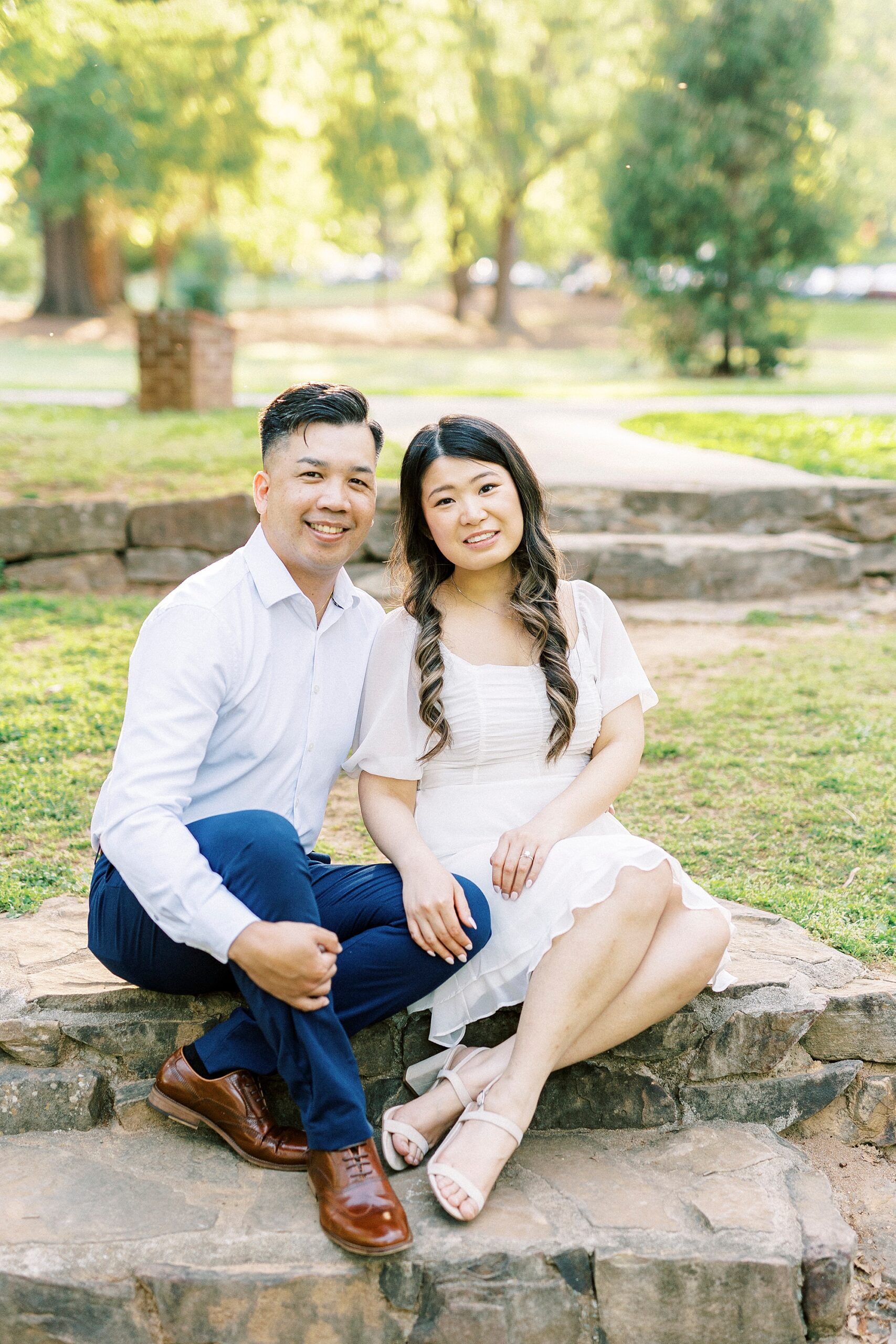 couple sits on stone staircase inside Glencairn Garden