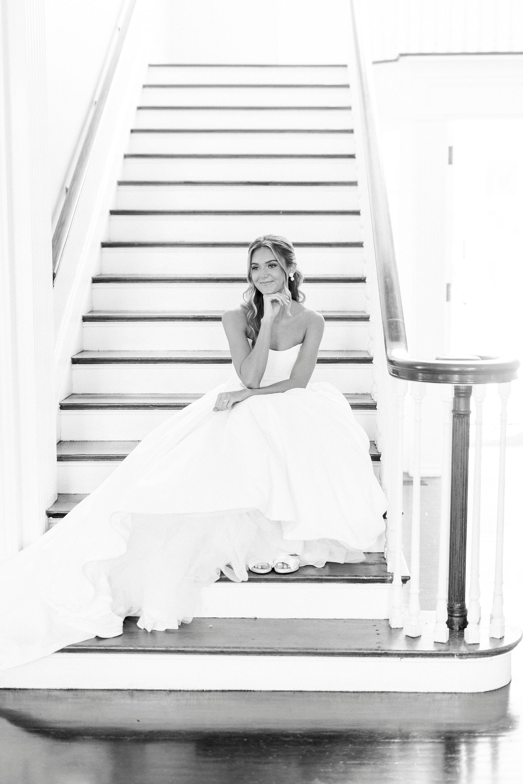 bride sits on steps leaning on first on knees during classic bridal portraits at Separk Mansion