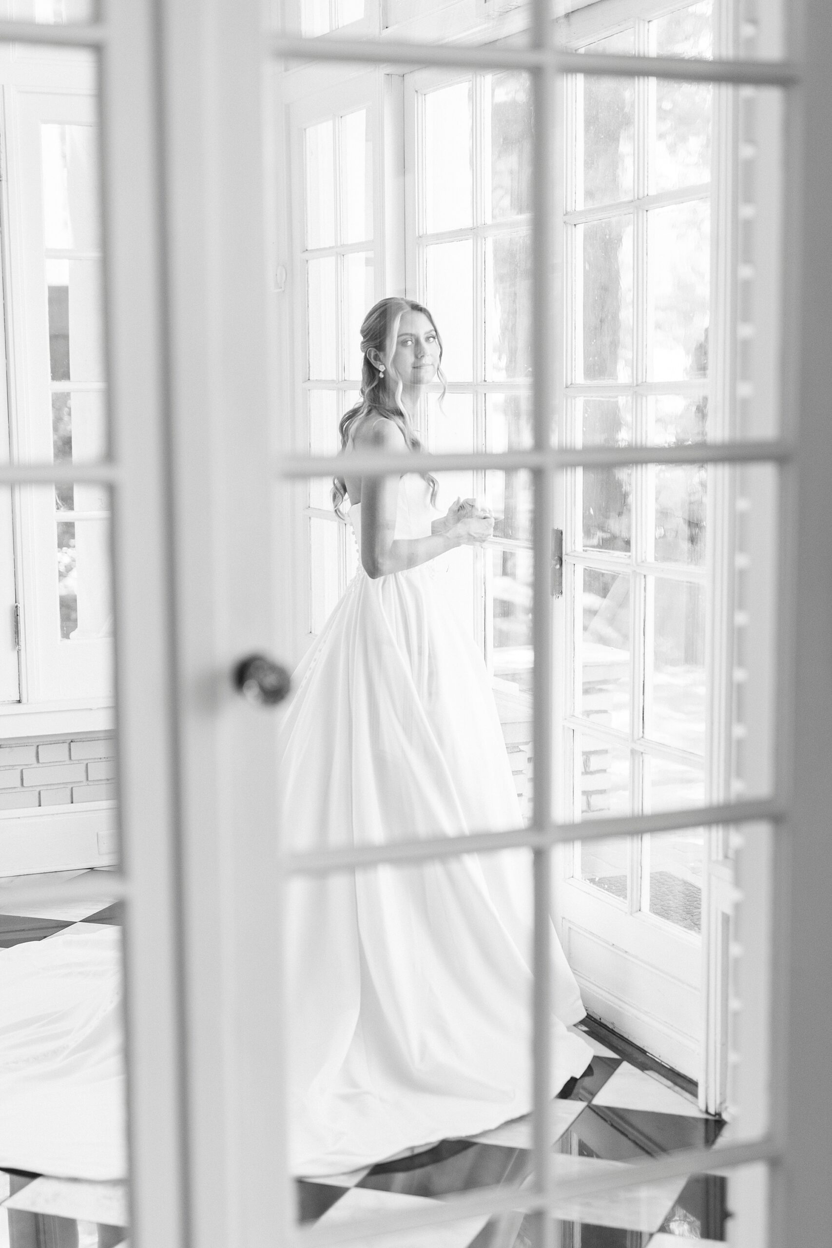 photo of bride through glass panes of door inside Separk Mansion