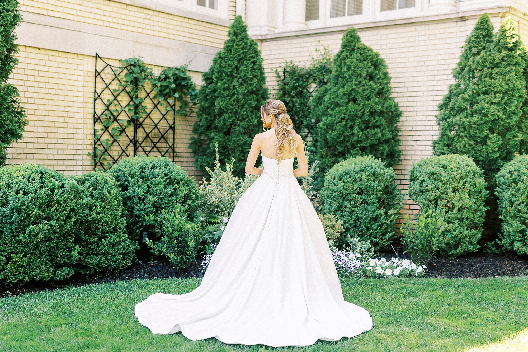 bride walks through gardens during classic bridal portraits at Separk Mansion