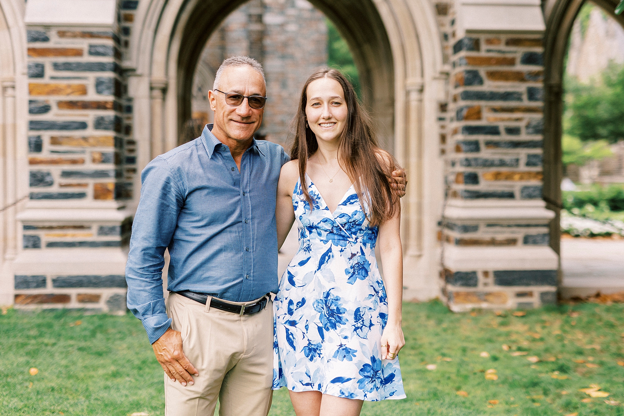 graduate poses with dad during family photos at Duke University