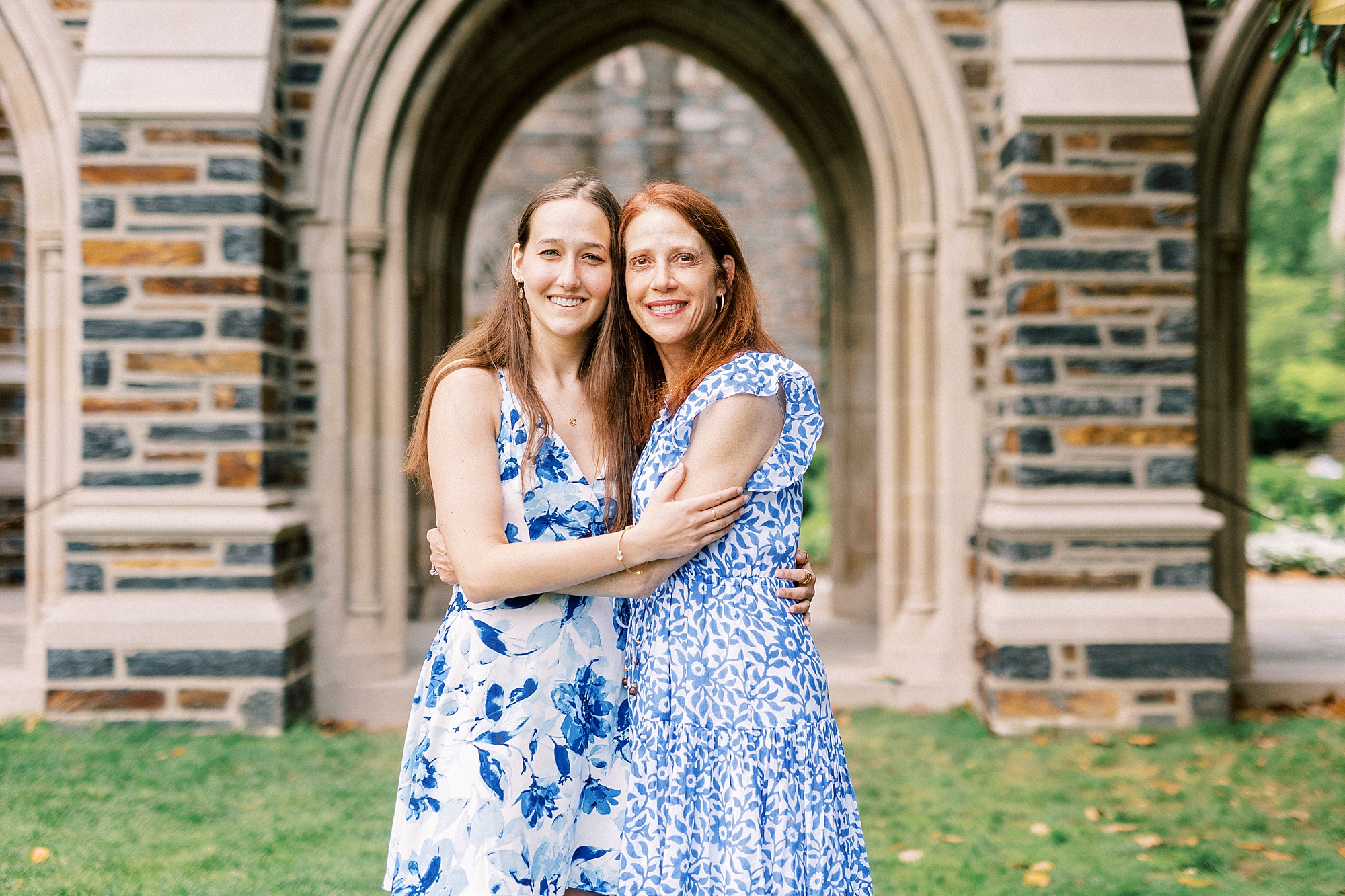 graduate hugs mom during family photos at Duke University