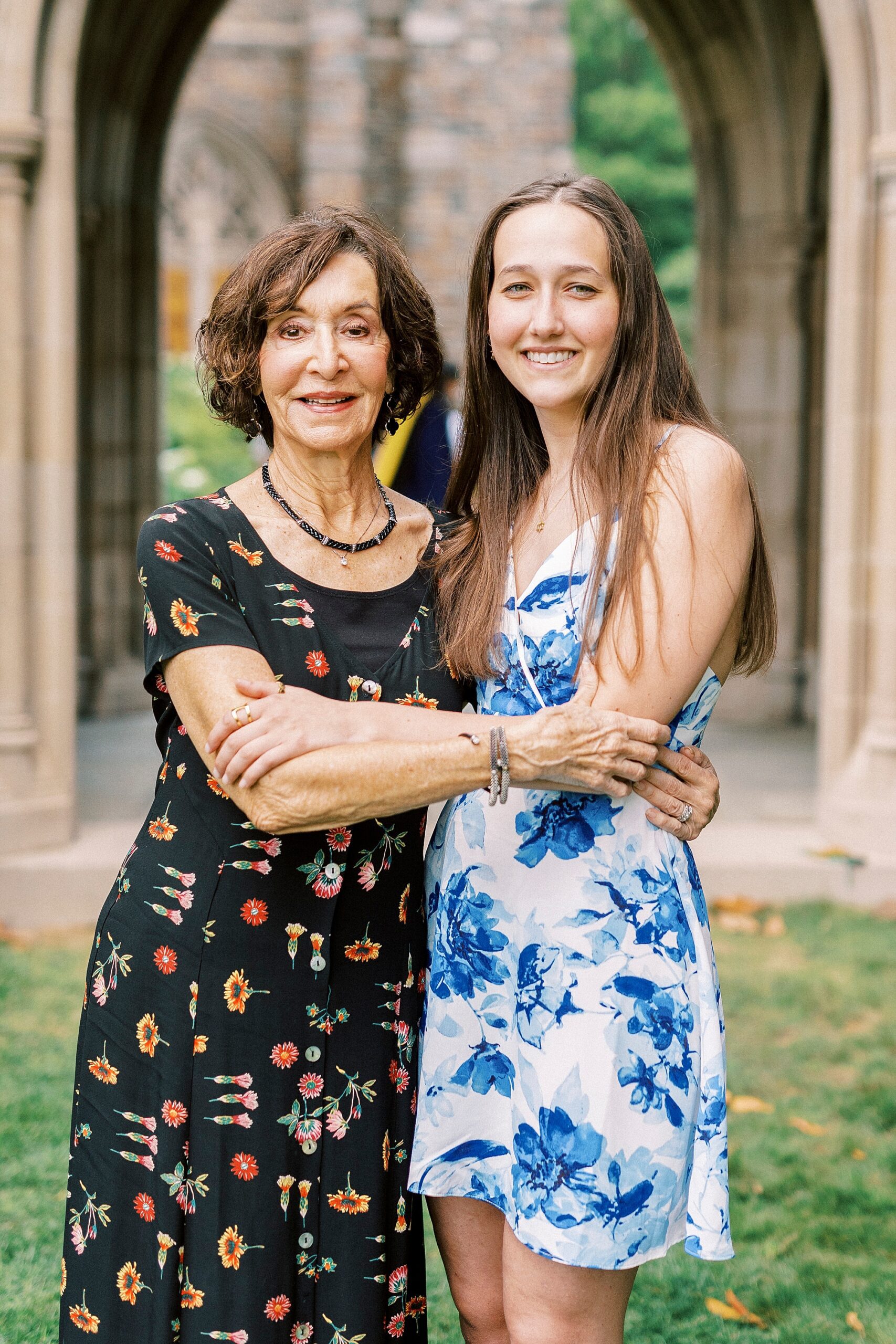 woman hugs graduate during family photos at Duke University