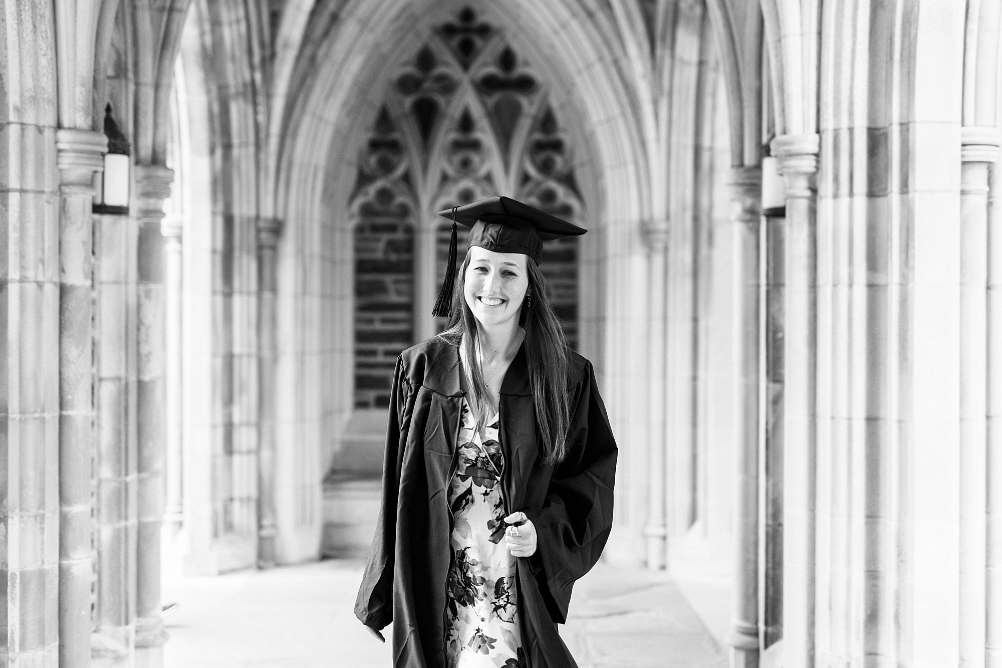 woman laughs and smiles in chapel during Duke University senior portraits
