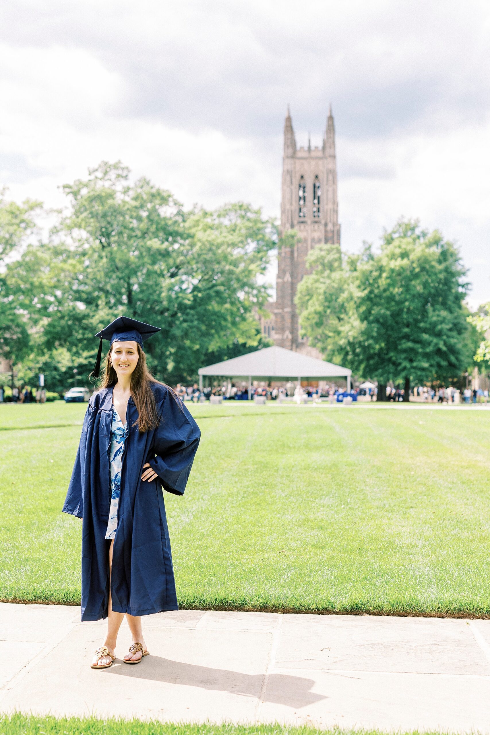 girl stands with hand on her hip near chapel building during Duke University senior portraits