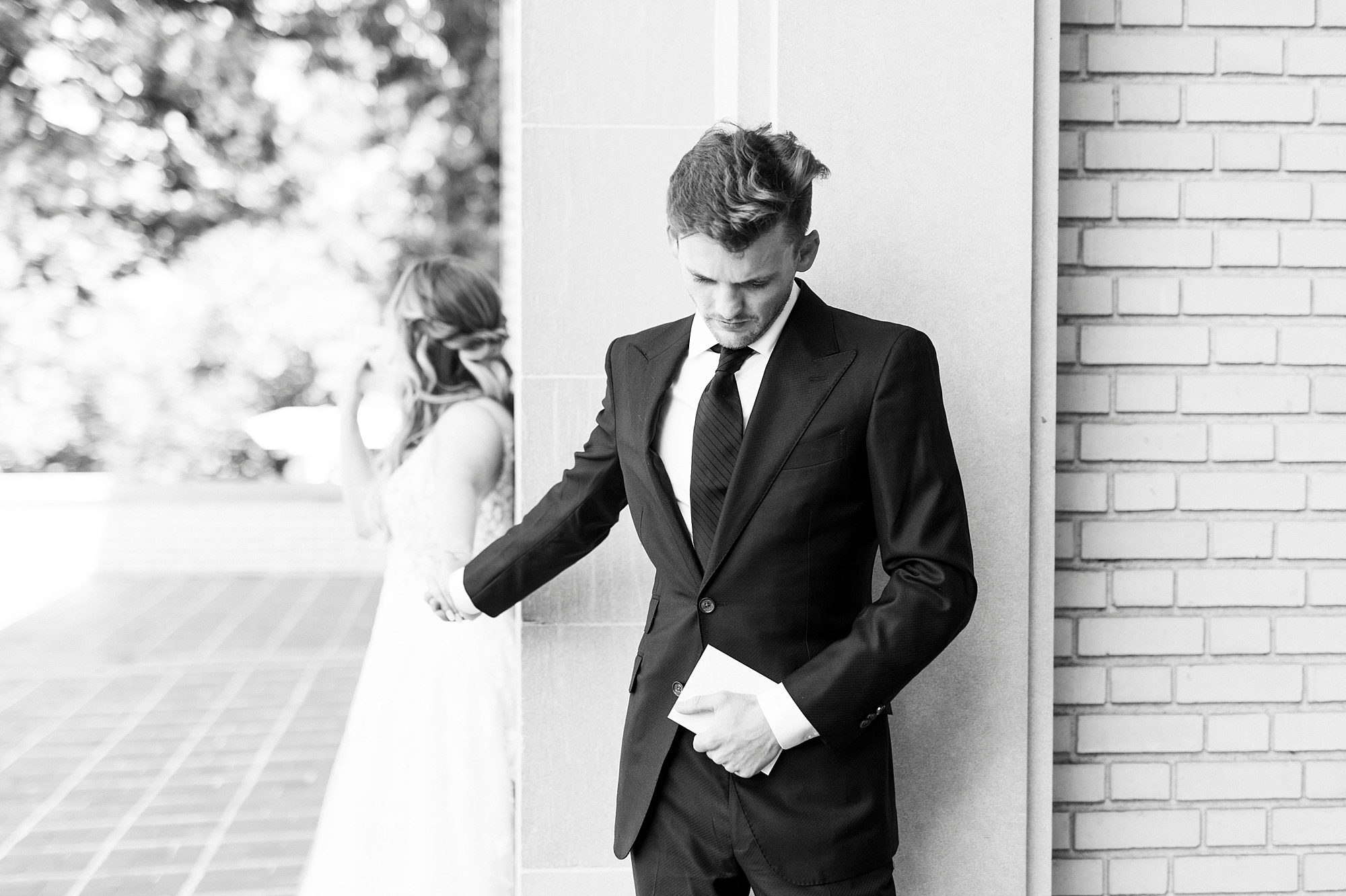 man prays during first touch with bride around corner at Separk Mansion