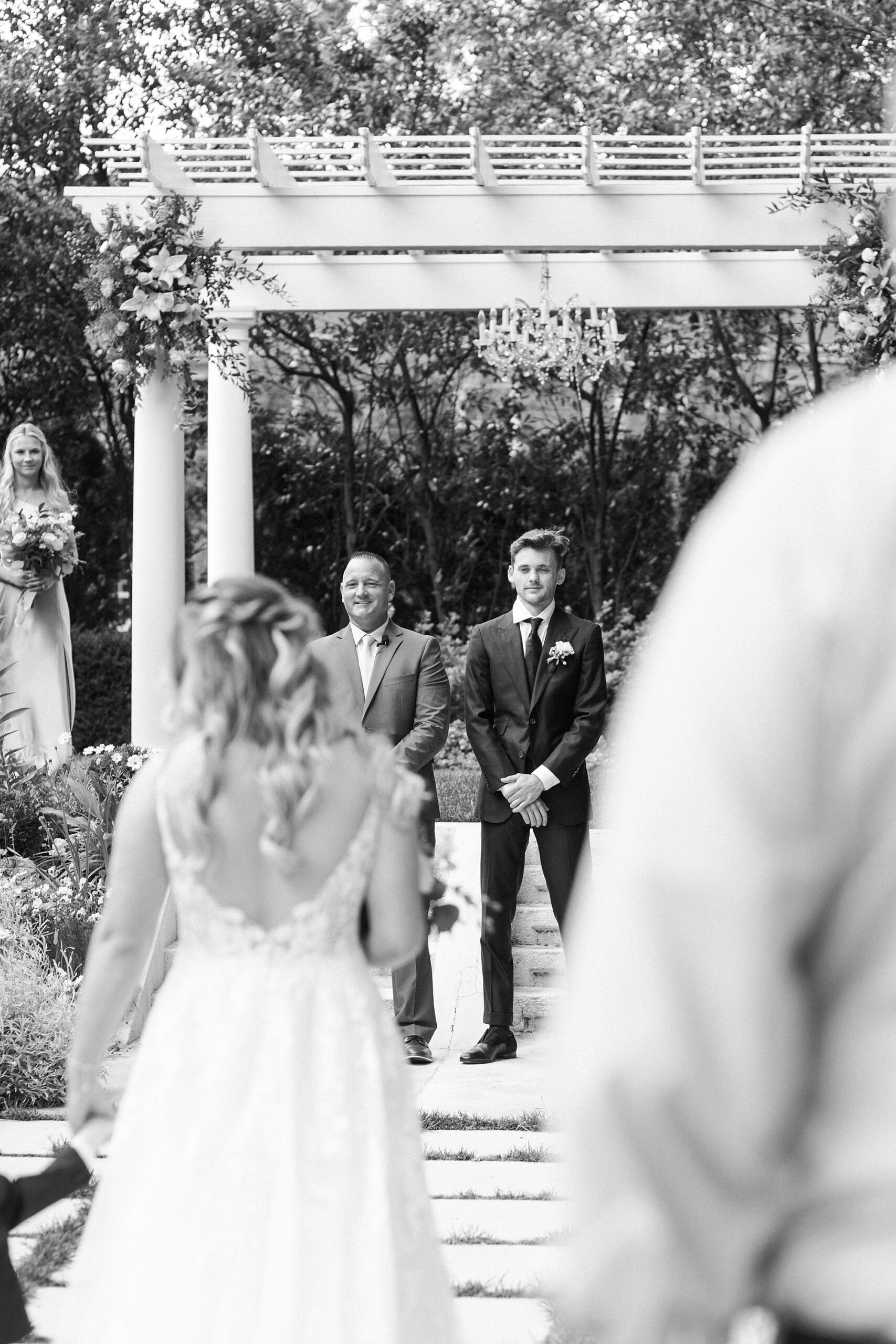groom watches bride and son walk down aisle during garden ceremony at Separk Mansion