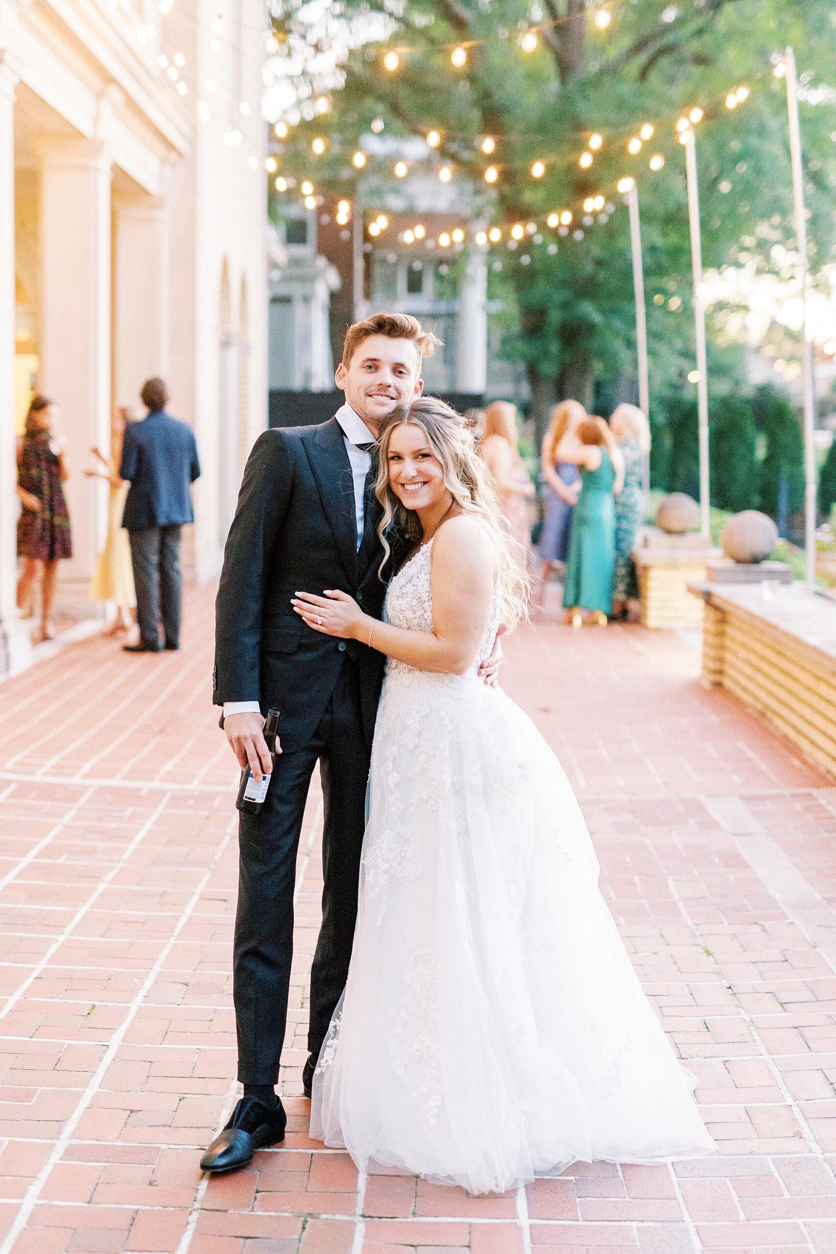 bride and groom stand on brick patio of Separk Mansion