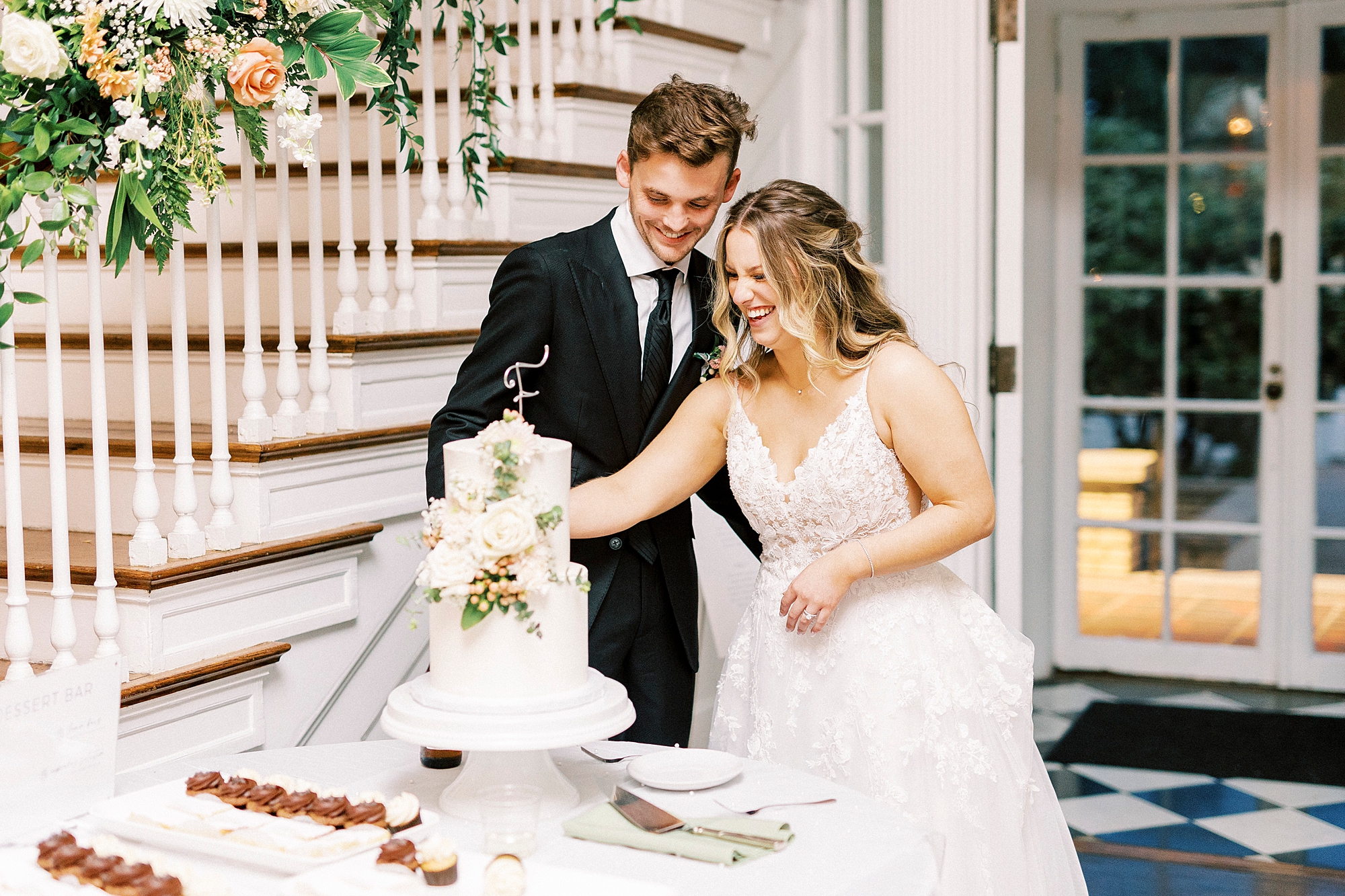 newlyweds cut wedding cake during NC wedding reception 