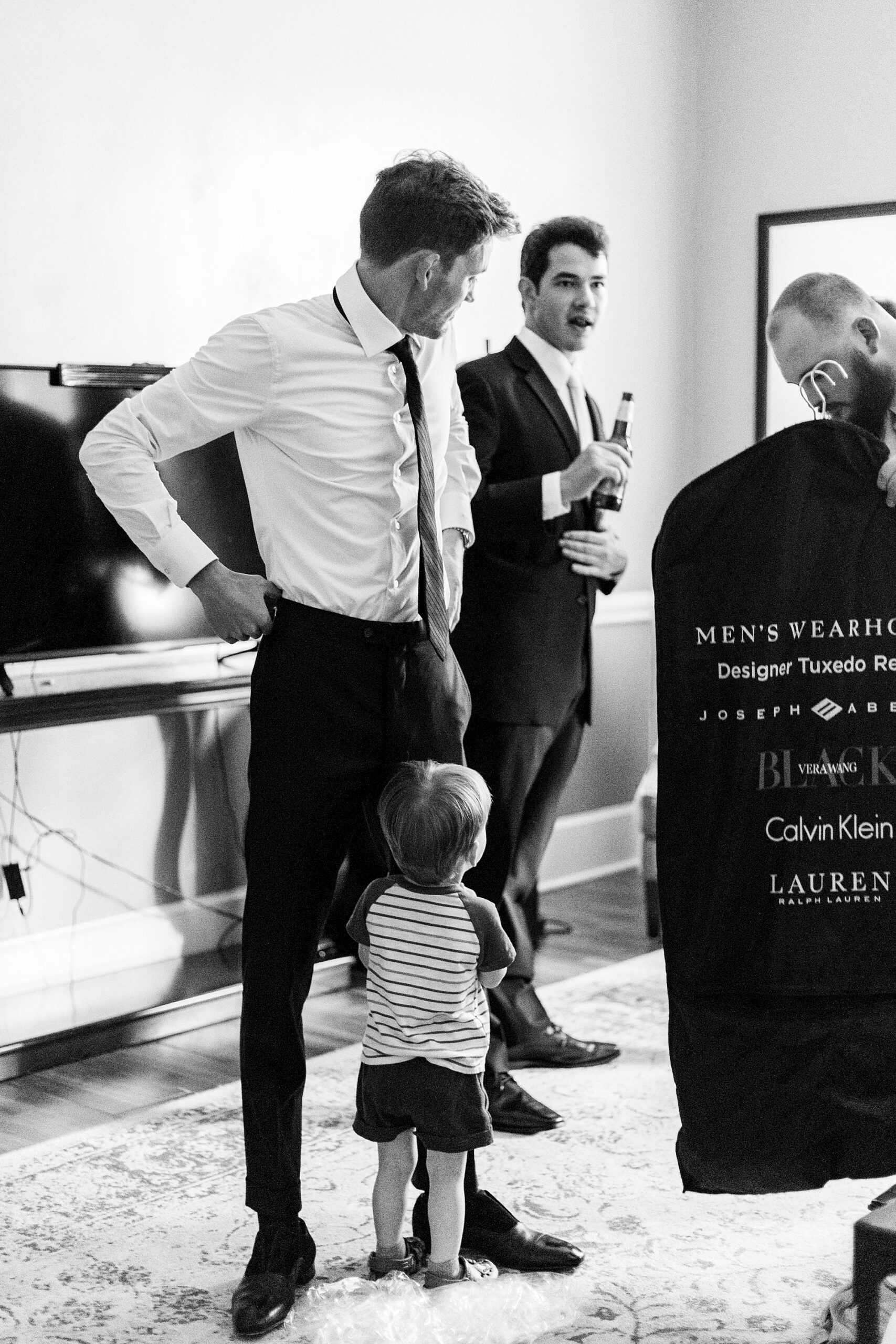 groom and son stand with groomsmen in suite at Separk Mansion