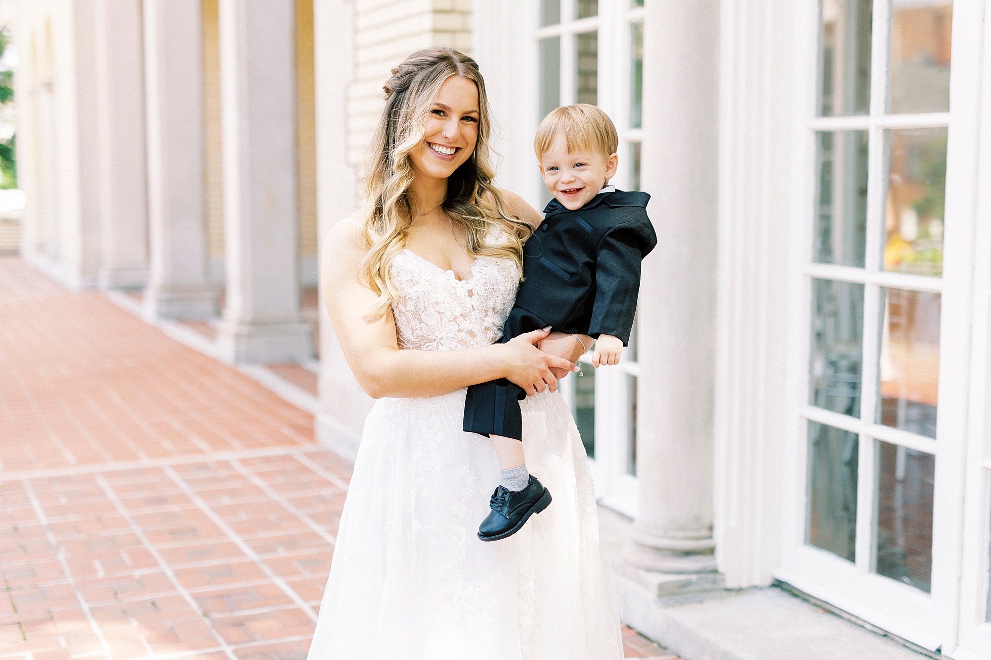bride and son laugh together during photos on brick patio at Separk Mansion