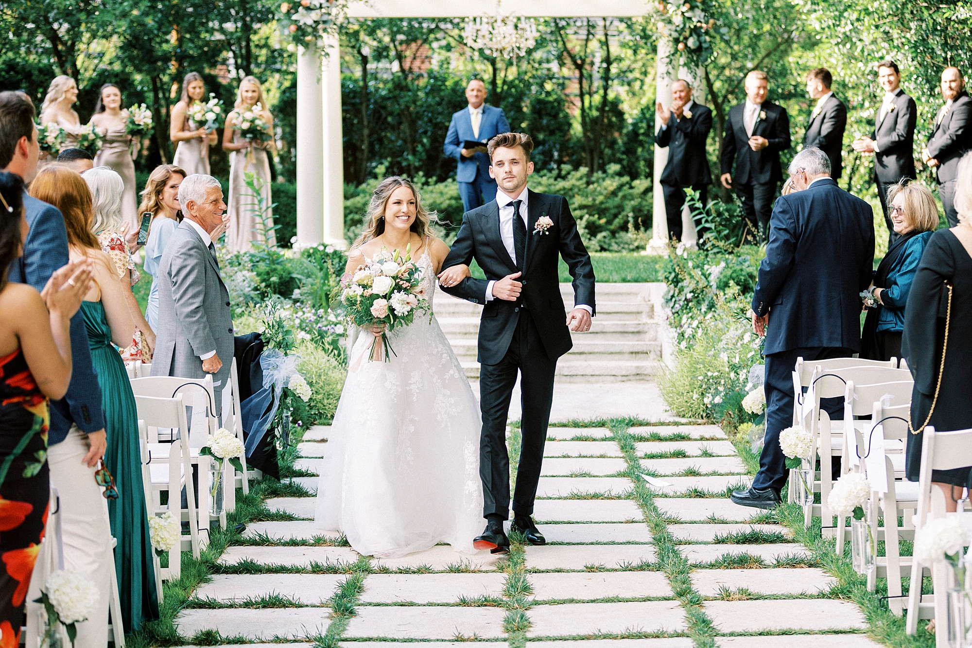 bride and groom walk up aisle during garden wedding ceremony at Separk Mansion