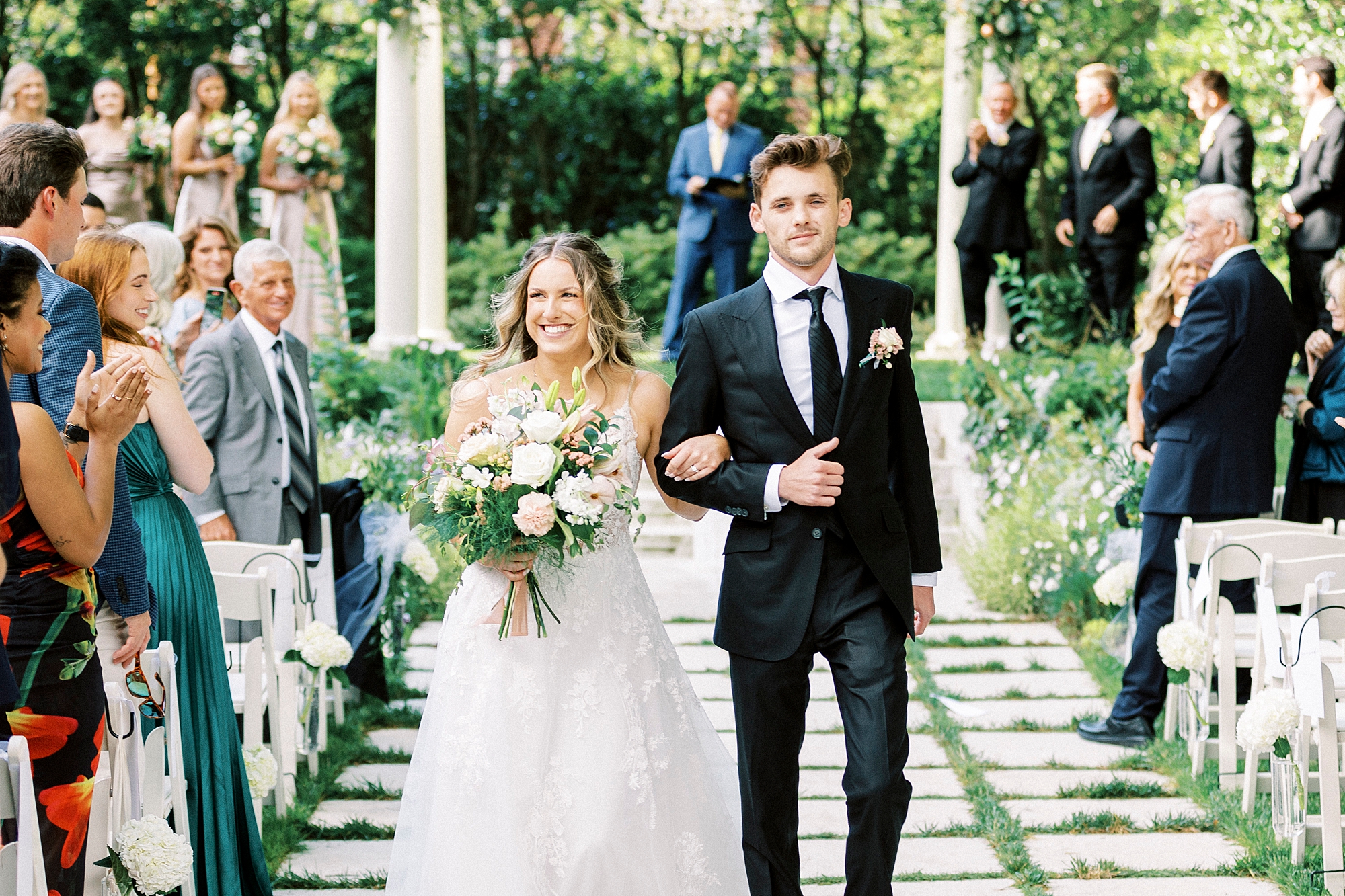 groom escorts bride up aisle after ceremony in Separk Mansion