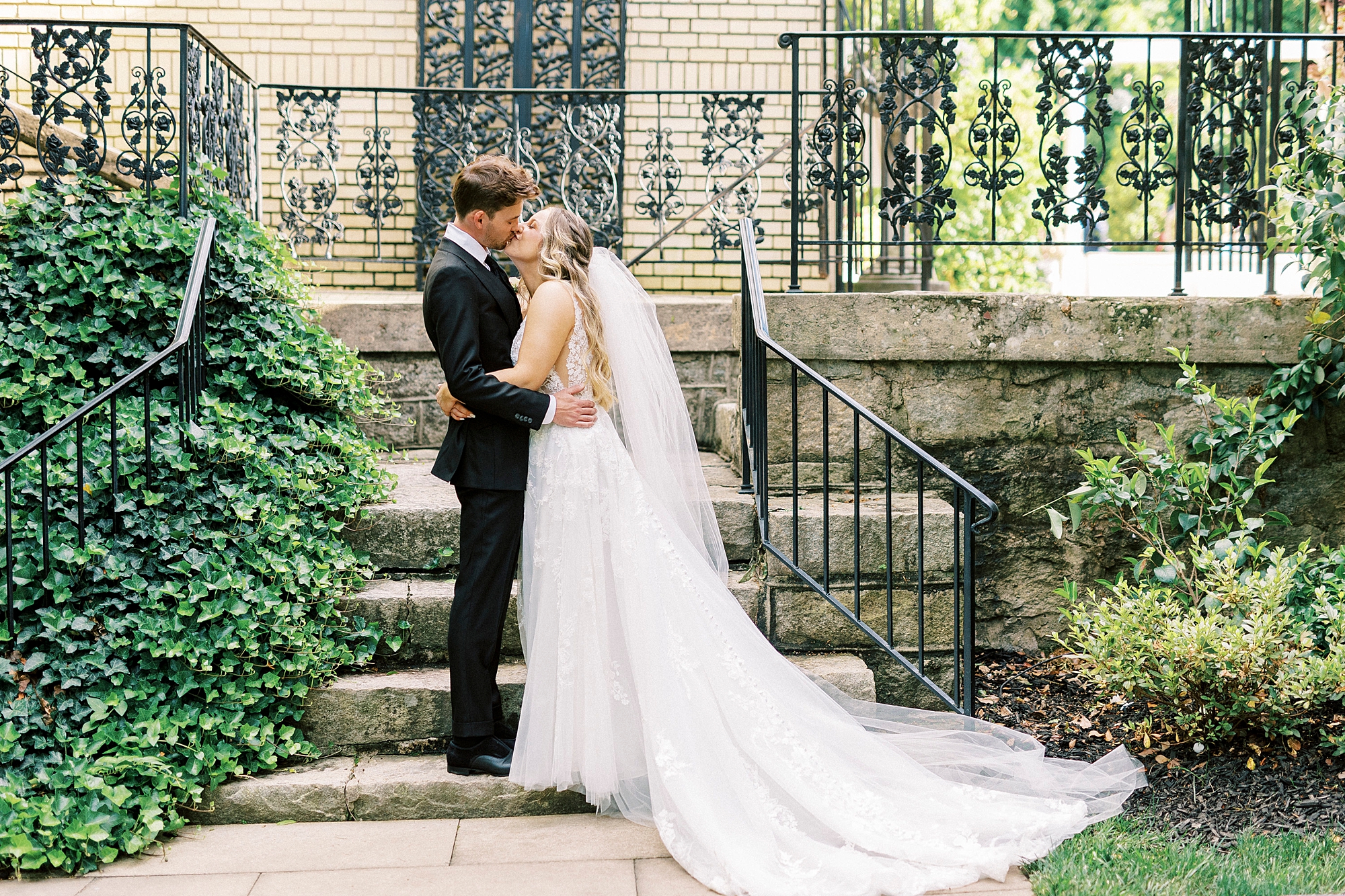 newlyweds kiss on stone steps at Separk Mansion