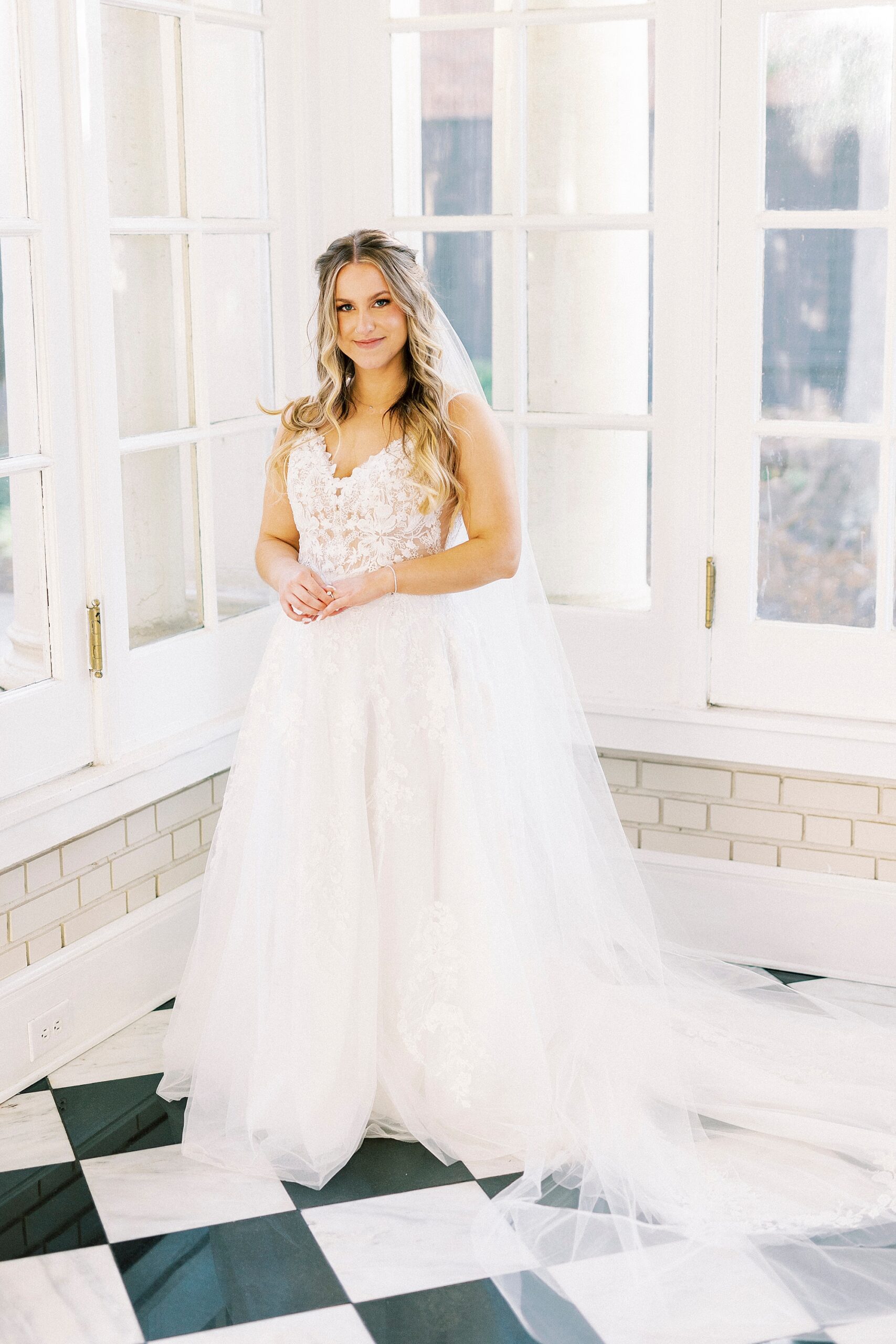 bride stands on black and white checkered floor inside Separk Mansion