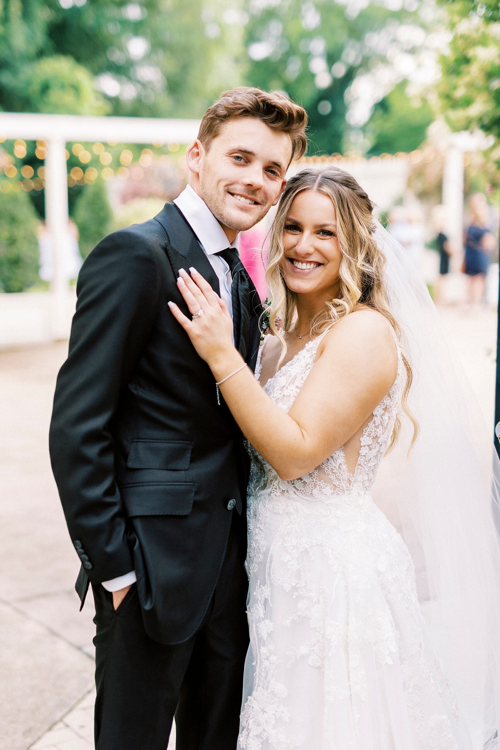 newlyweds hug on patio at Separk Mansion