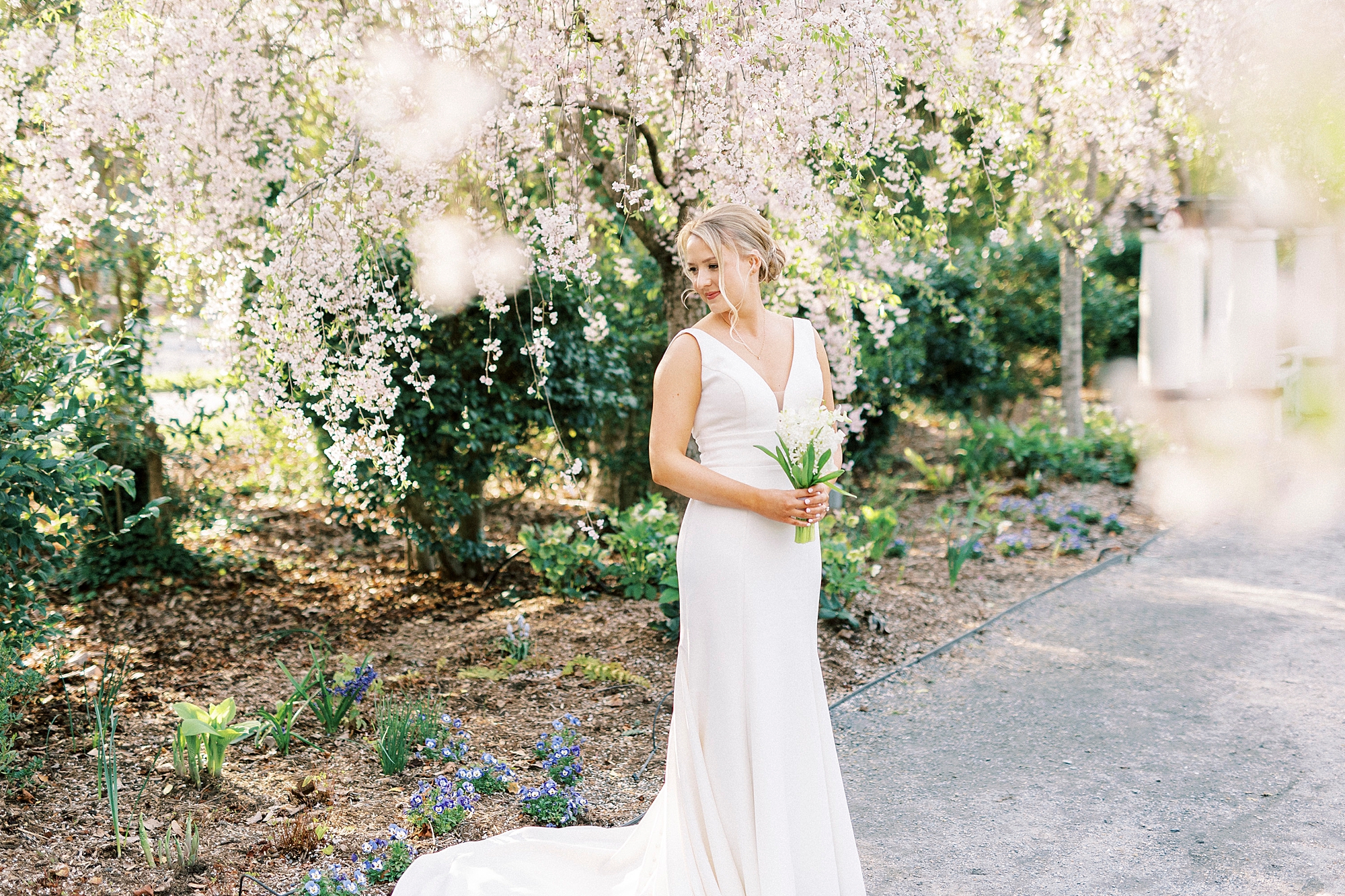 bride holds bouquet of white hyacinths during Reynolda Gardens bridal session