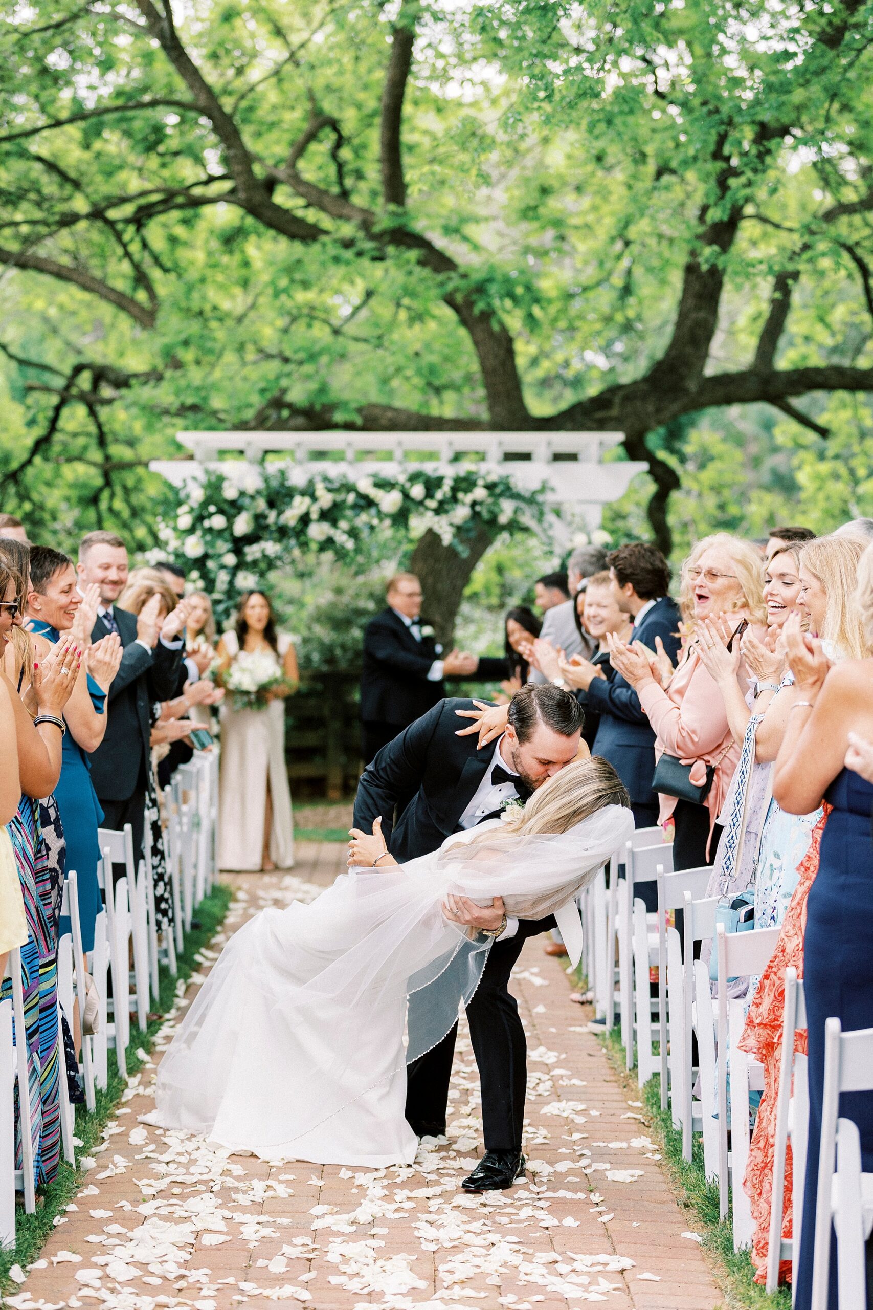 groom dips bride leaving wedding ceremony at the Venues at Langtree