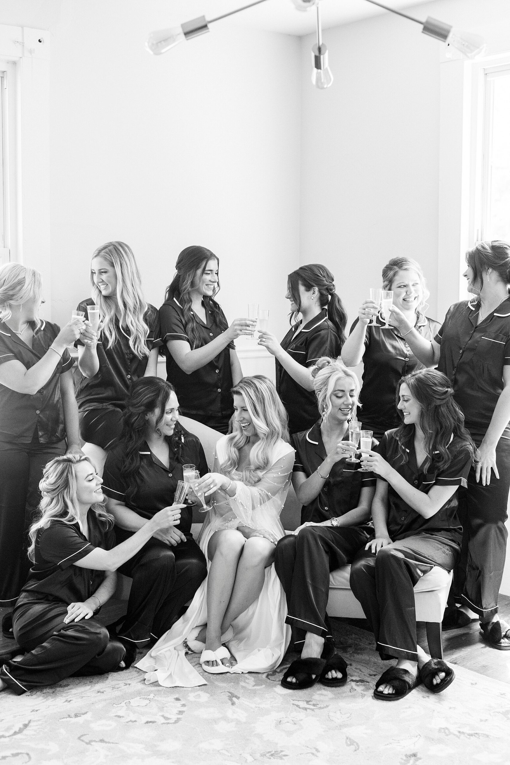 bride and bridesmaids toast Champagne during prep at the Venues at Langtree