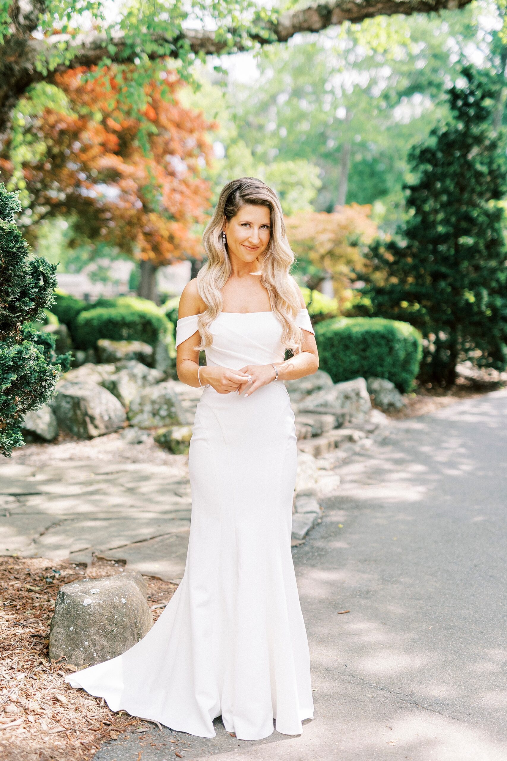 bride looks down over shoulder in off-the-shoulder gown